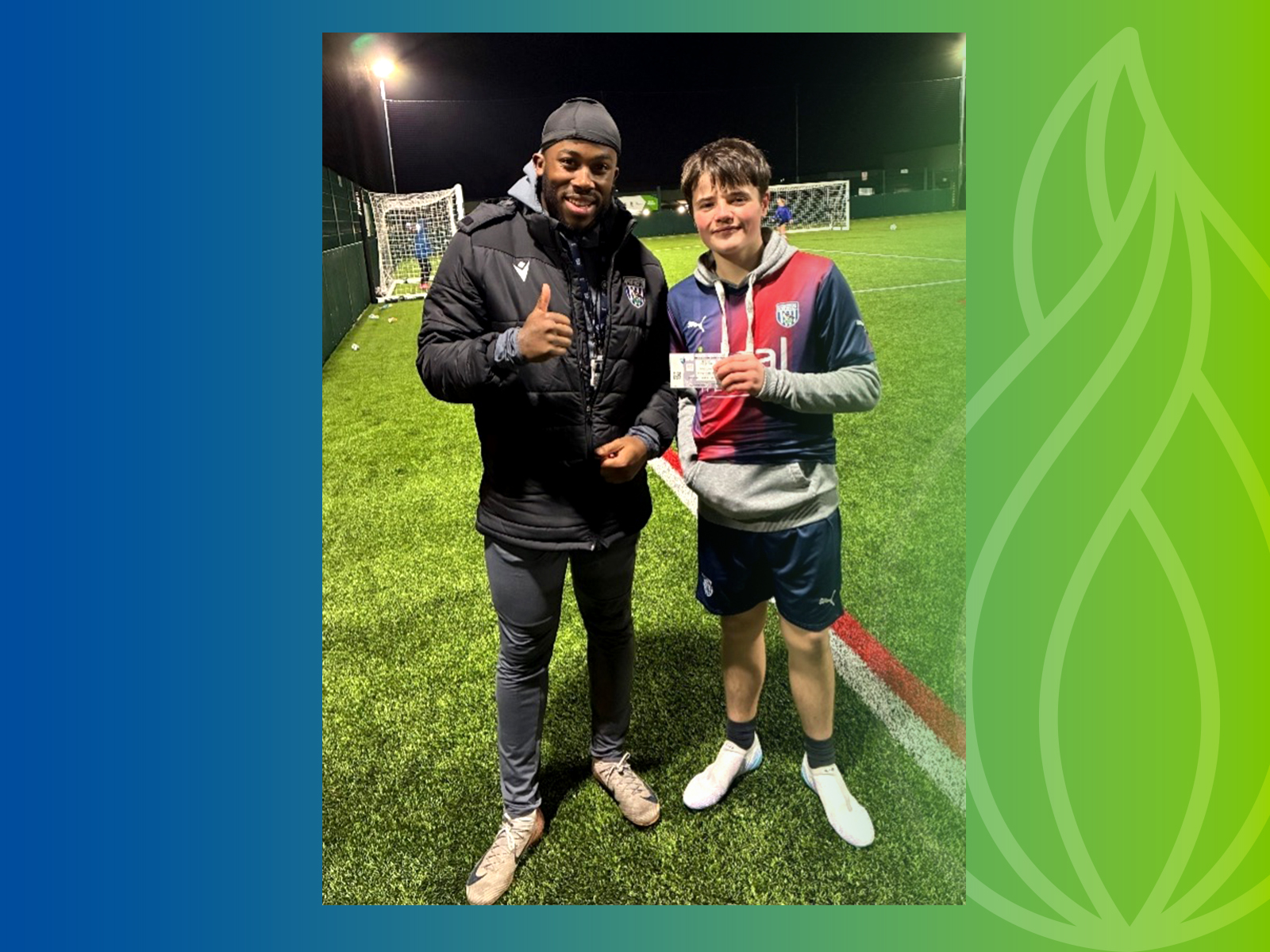 Sam, holding WBA ticket, standing with Youth Engagement Coach Kadeem 