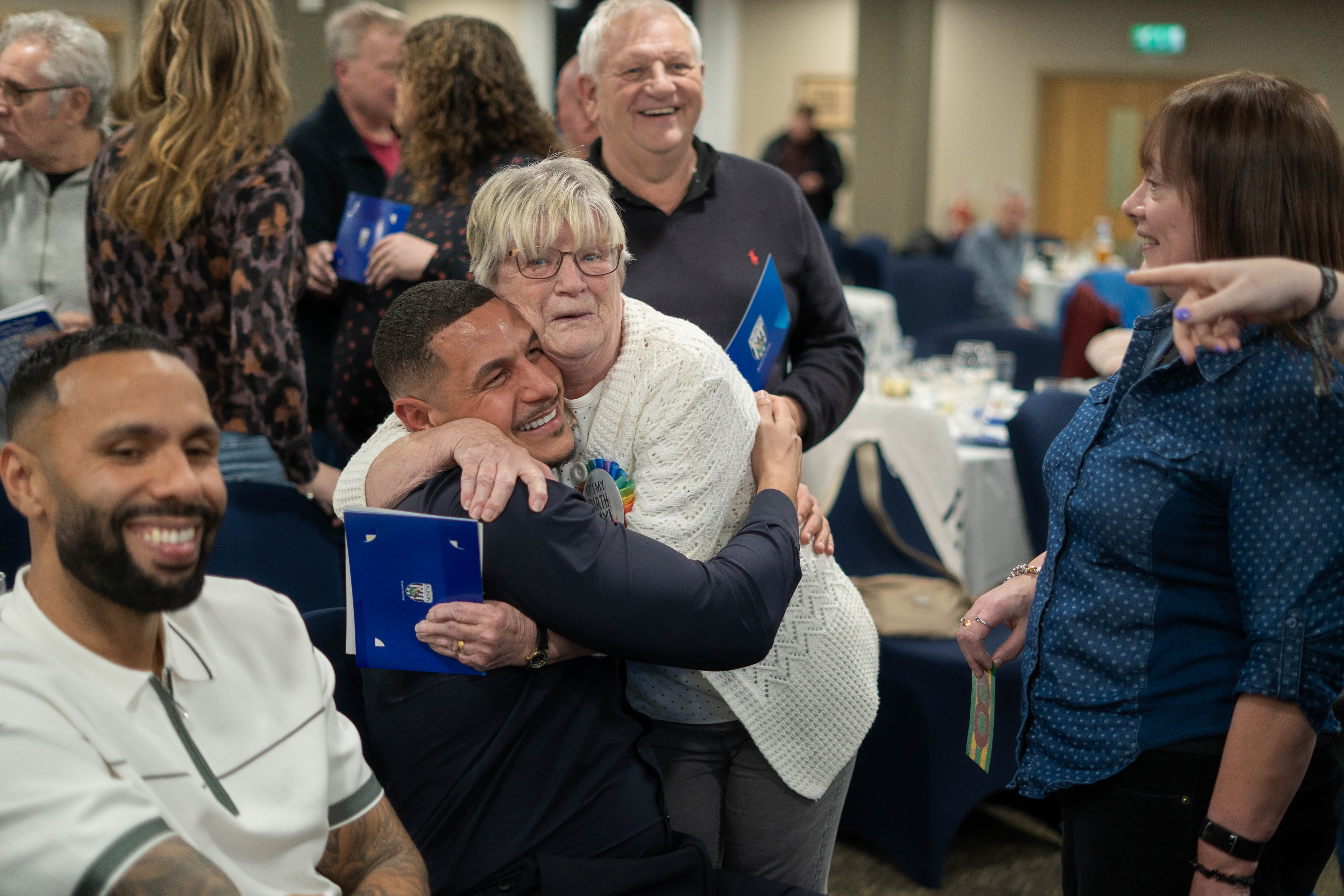 Jake Livermore and a fan in a warm embrace 