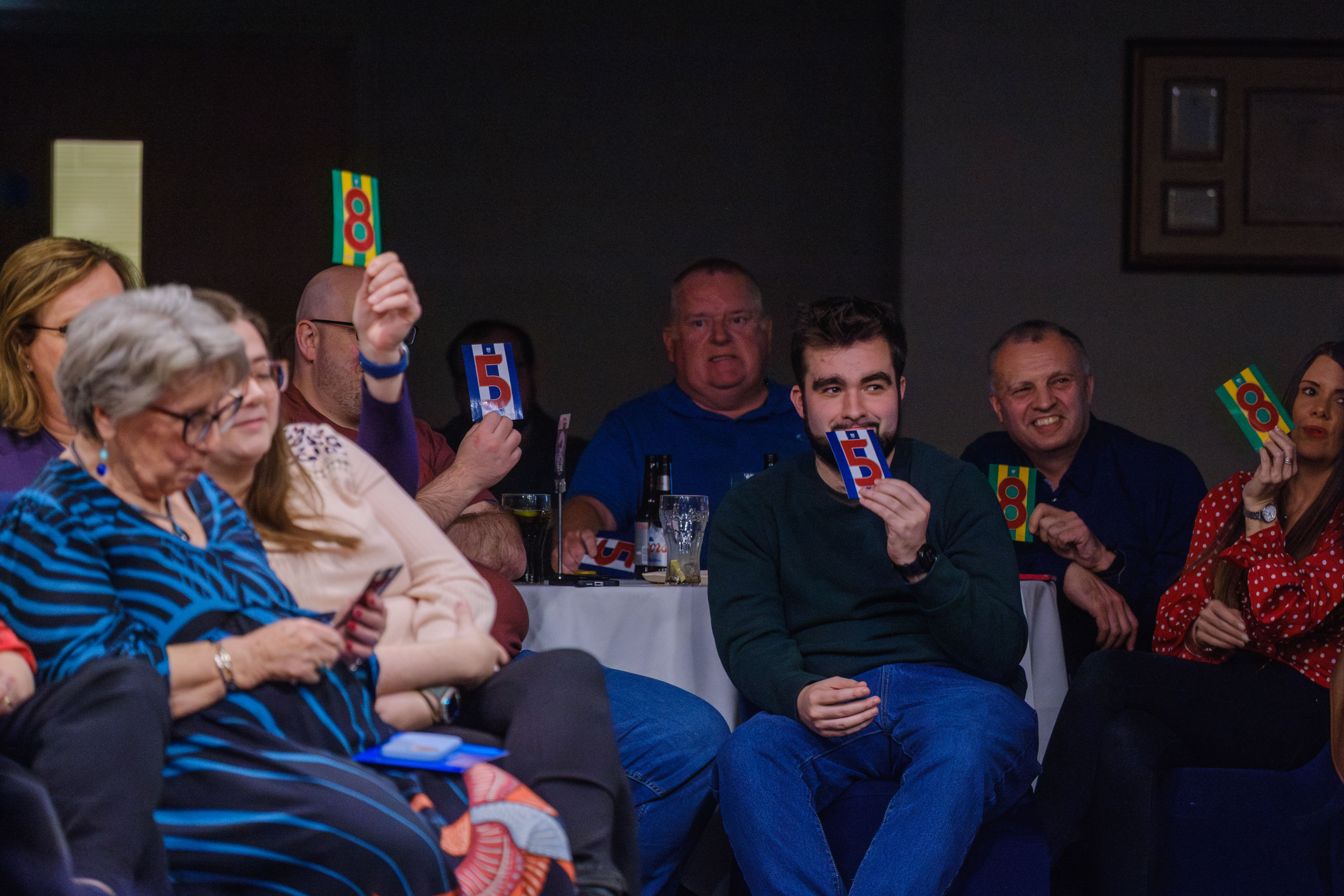 The audience taking part in a game, holding up cards with Bartley and Livermore's shirt numbers