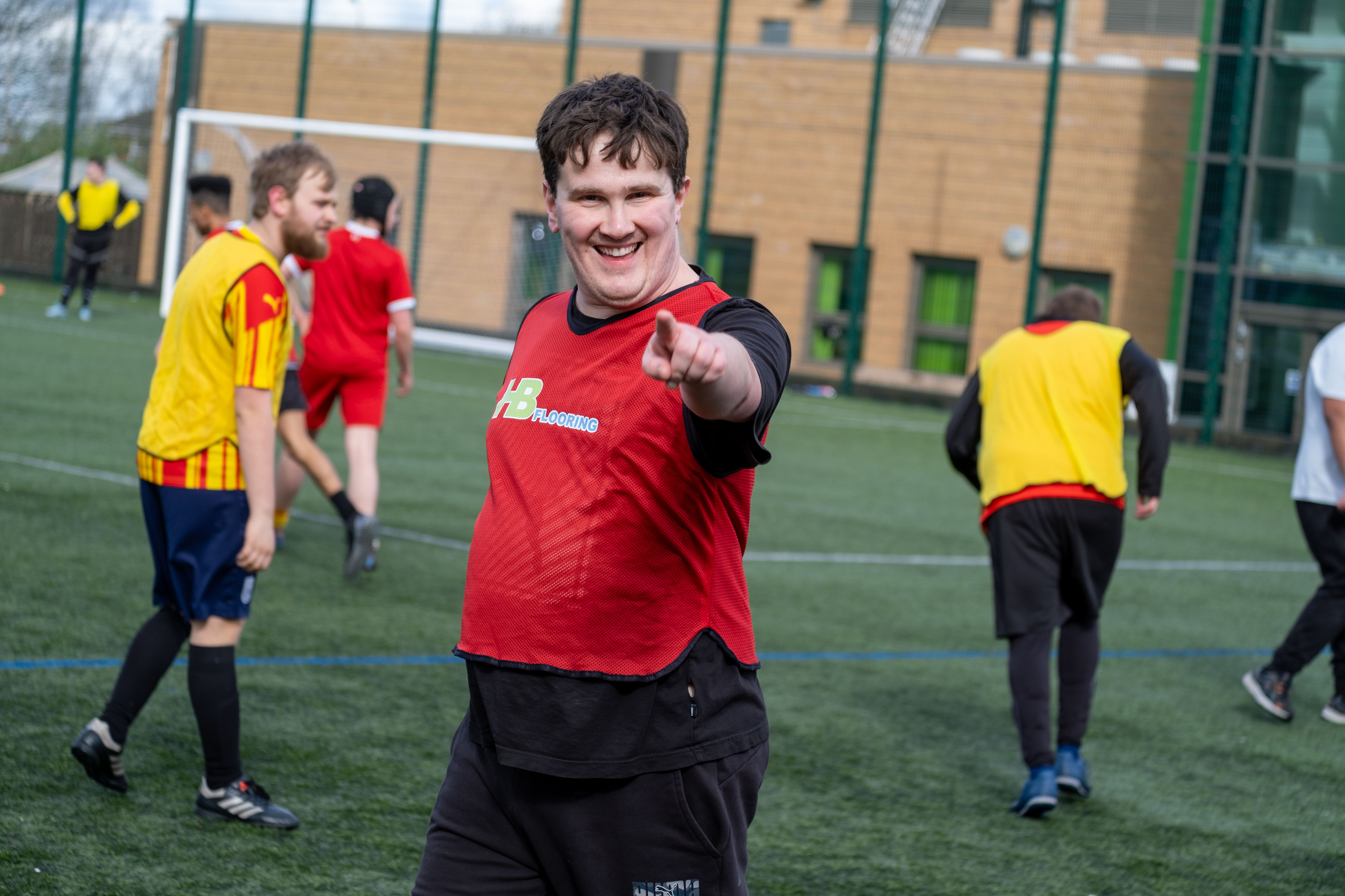 SEND Camp participant smiling and pointing
