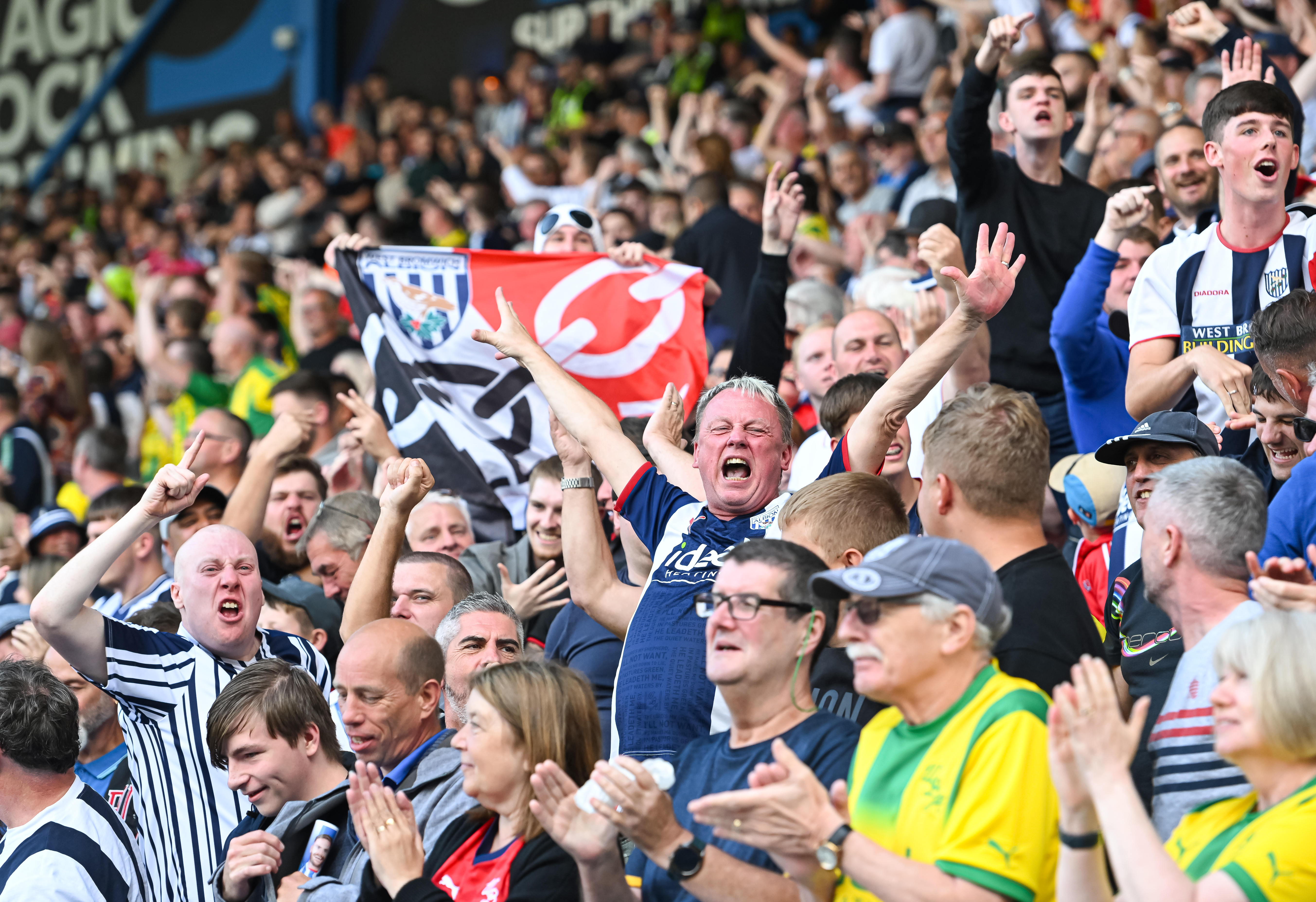 A general view of several WBA fans cheering in the stand