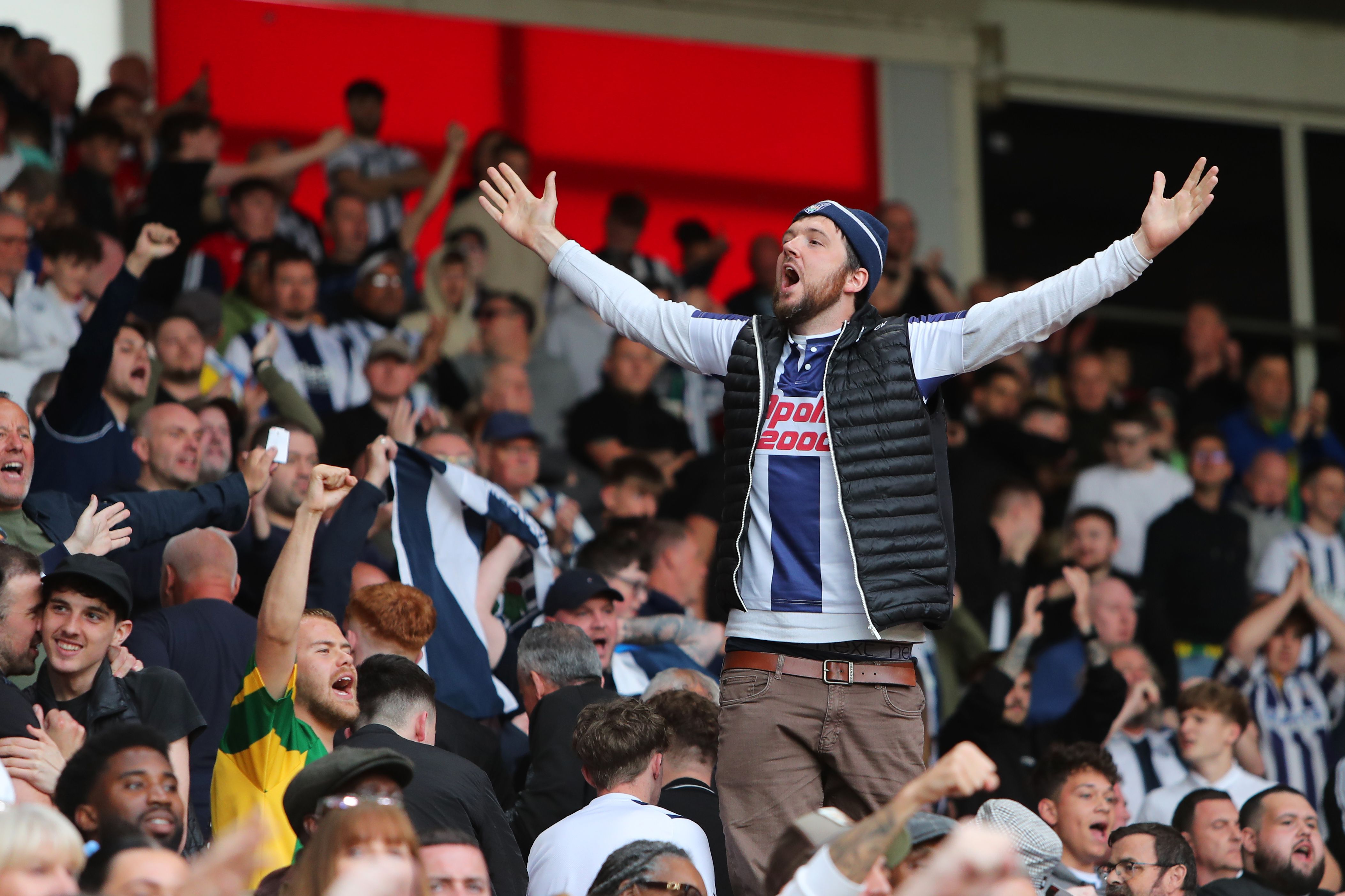 A WBA fan in the away end stood up and chanting 
