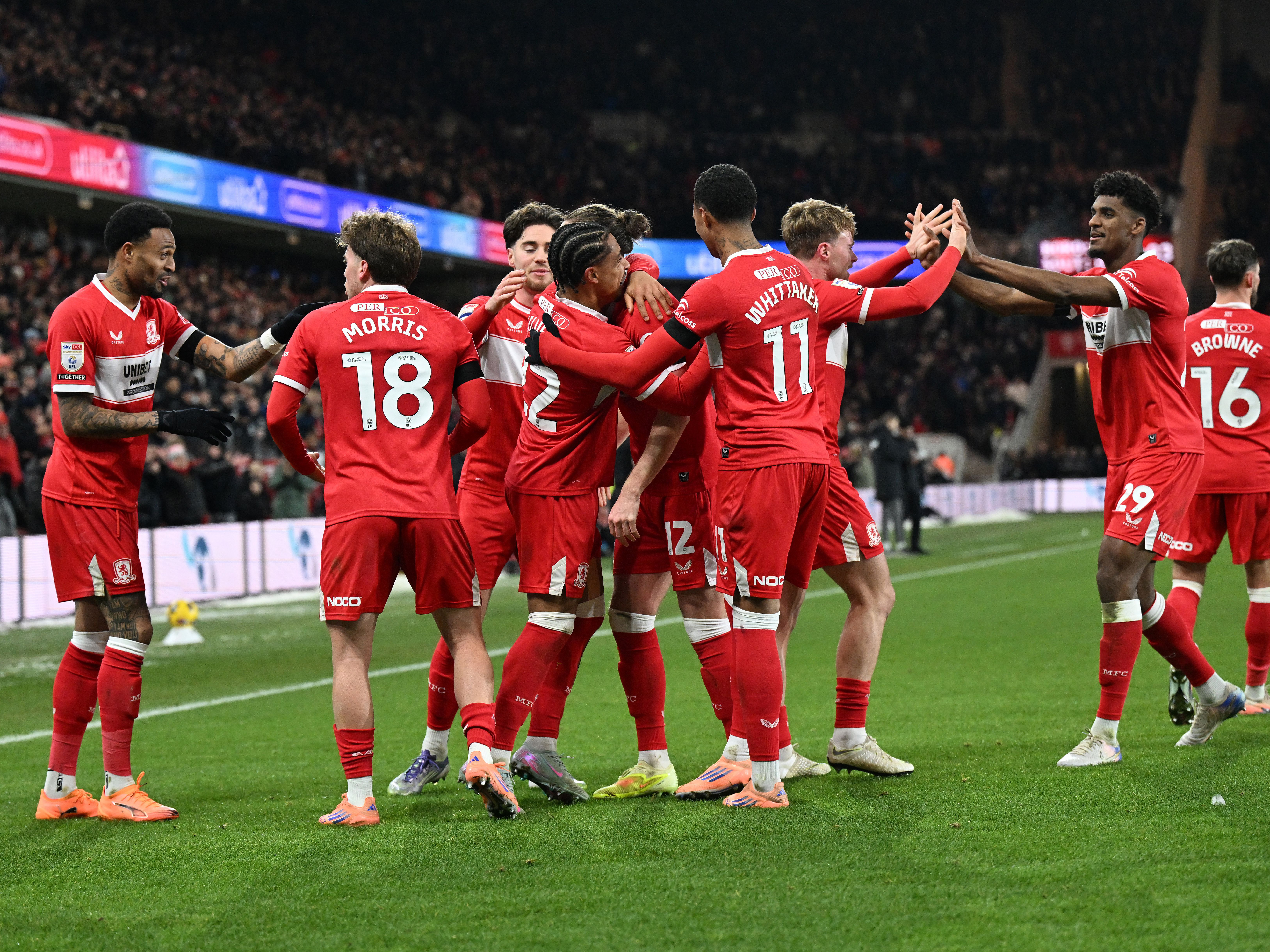 Several Middlesbrough players celebrate a goal in their home kit 