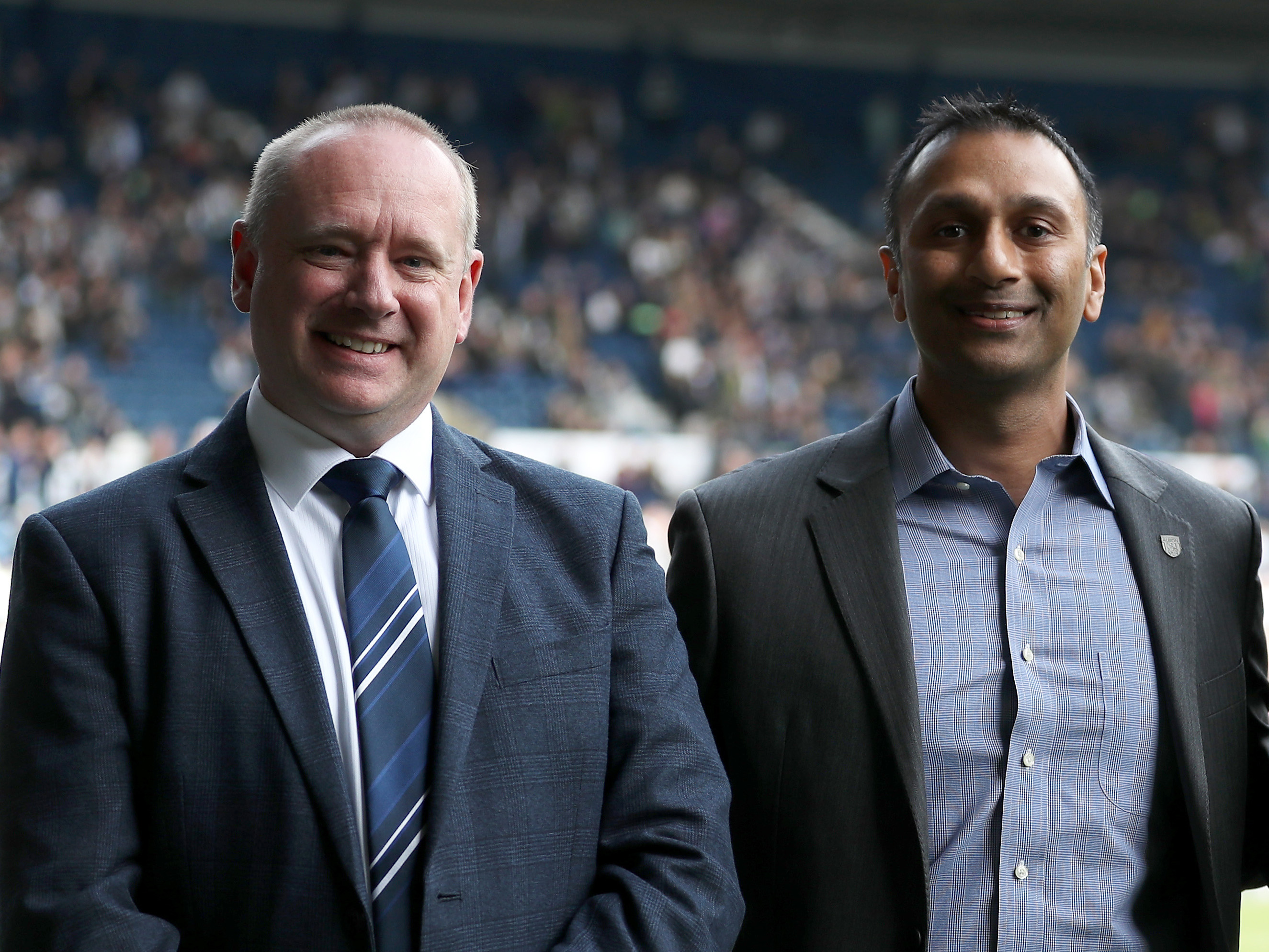 Mark Miles and Shilen Patel smiling at the camera while at The Hawthorns 