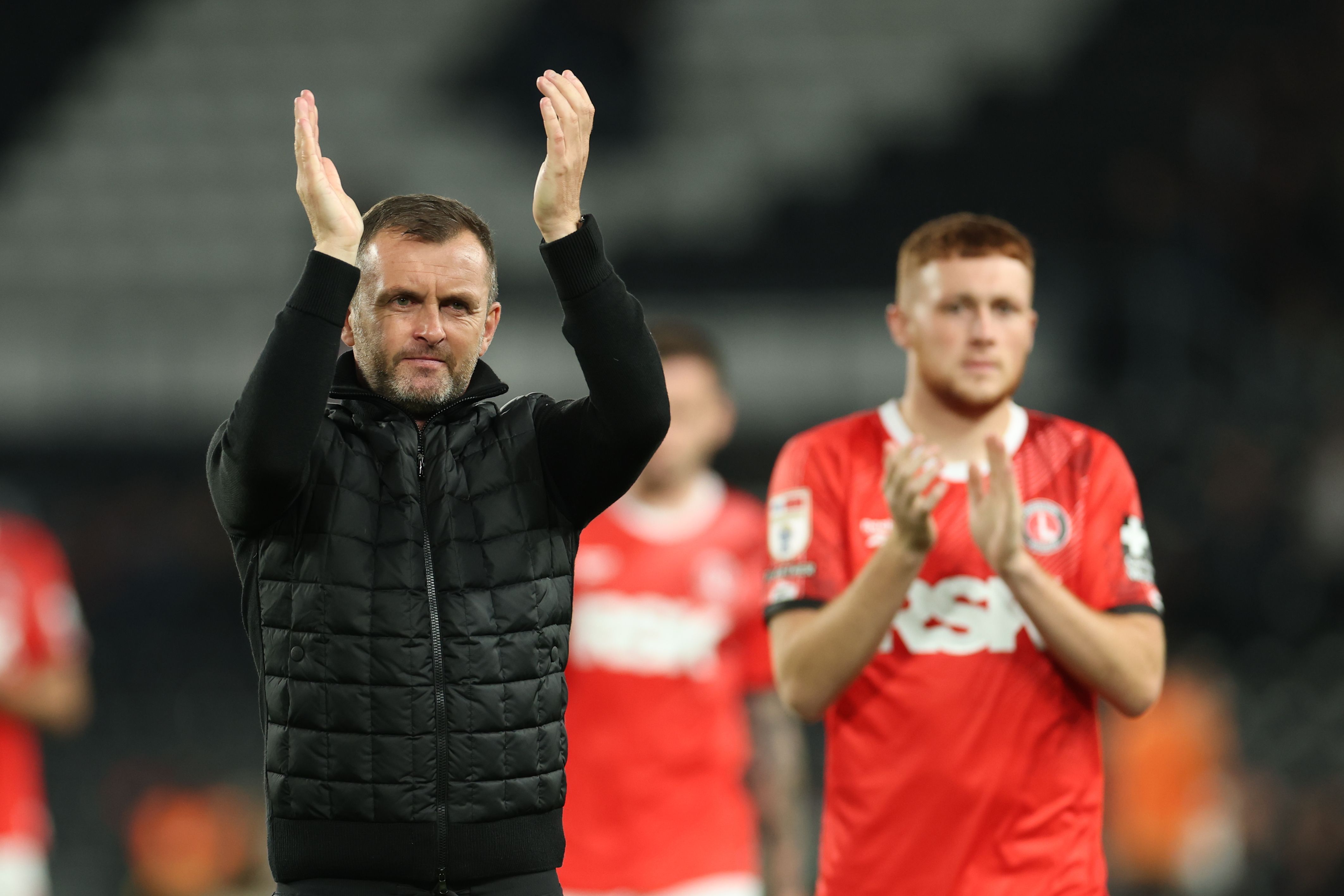 Charlton boss Nathan Jones applauding supporters 