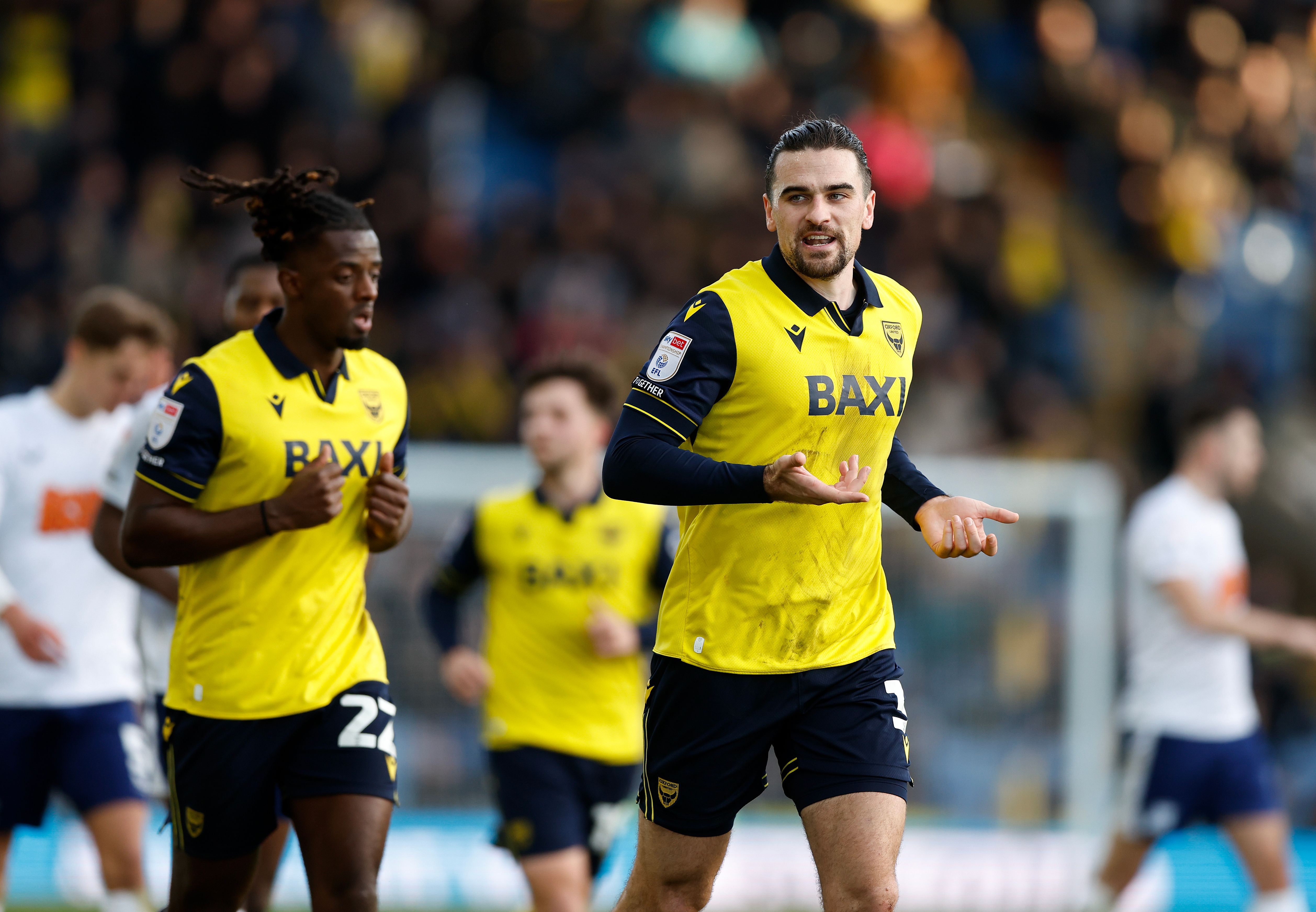 Two Oxford players in their home kit 