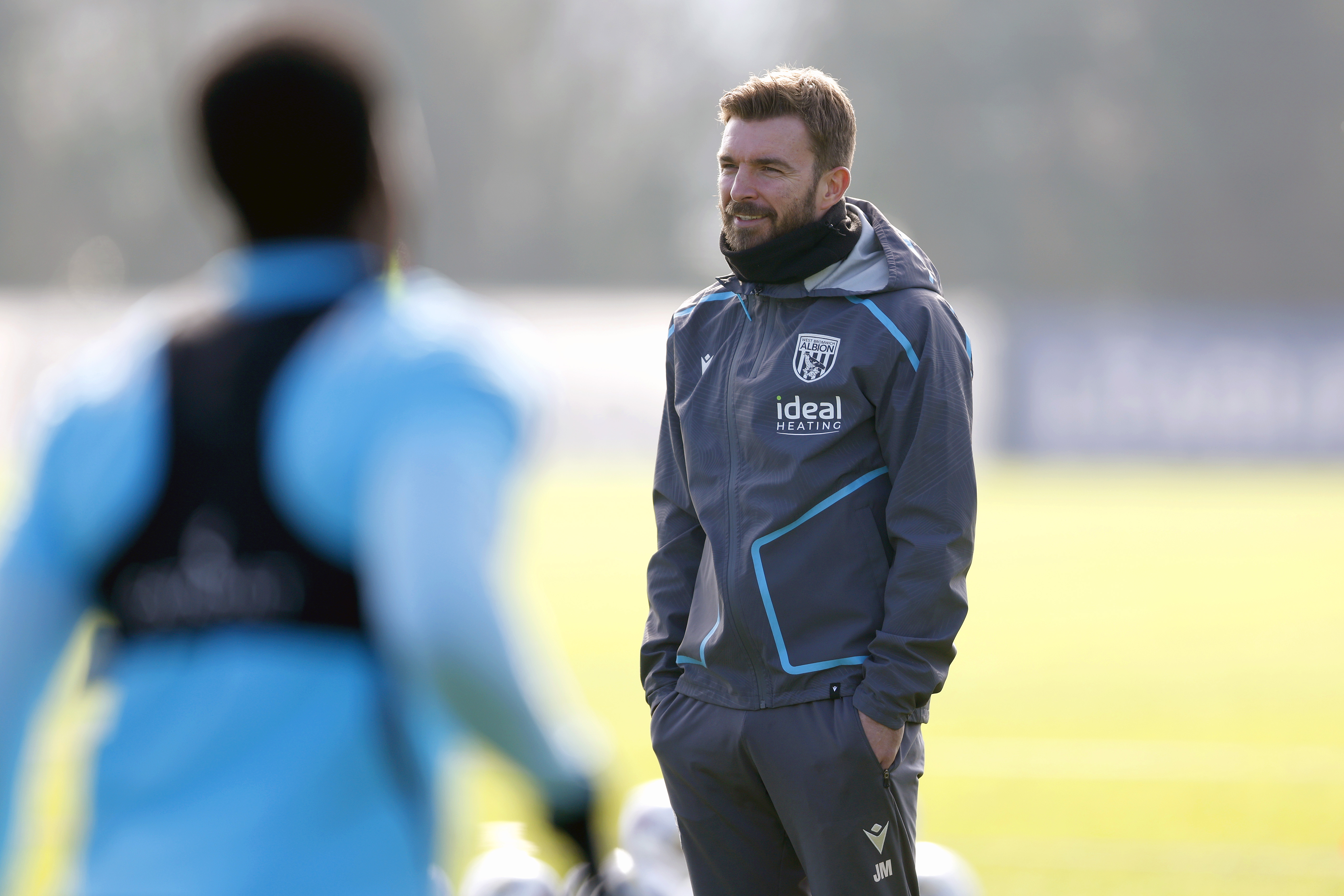 James Morrison smiling while watching a training session