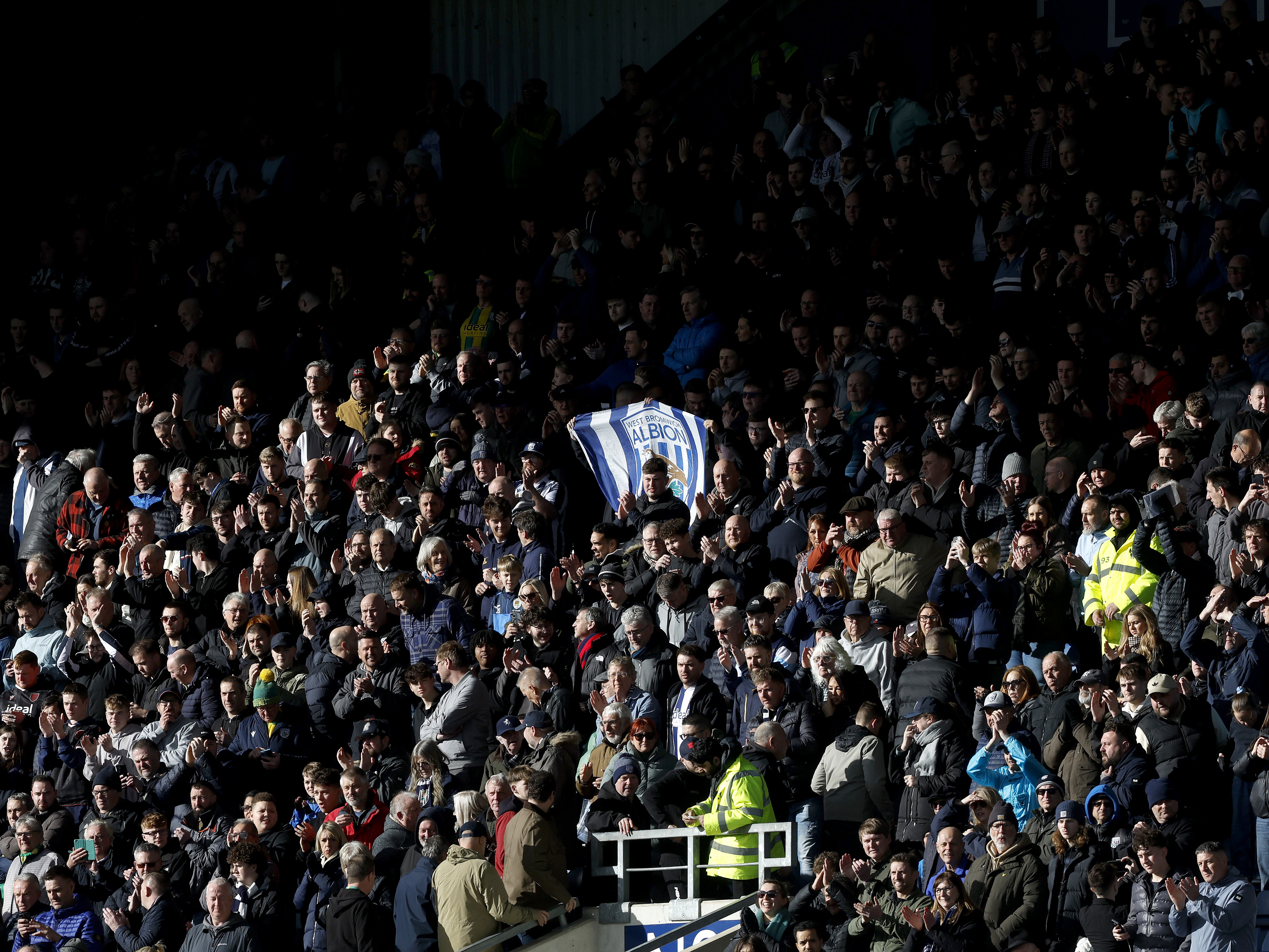 An image of Albion fans in a packed out away end