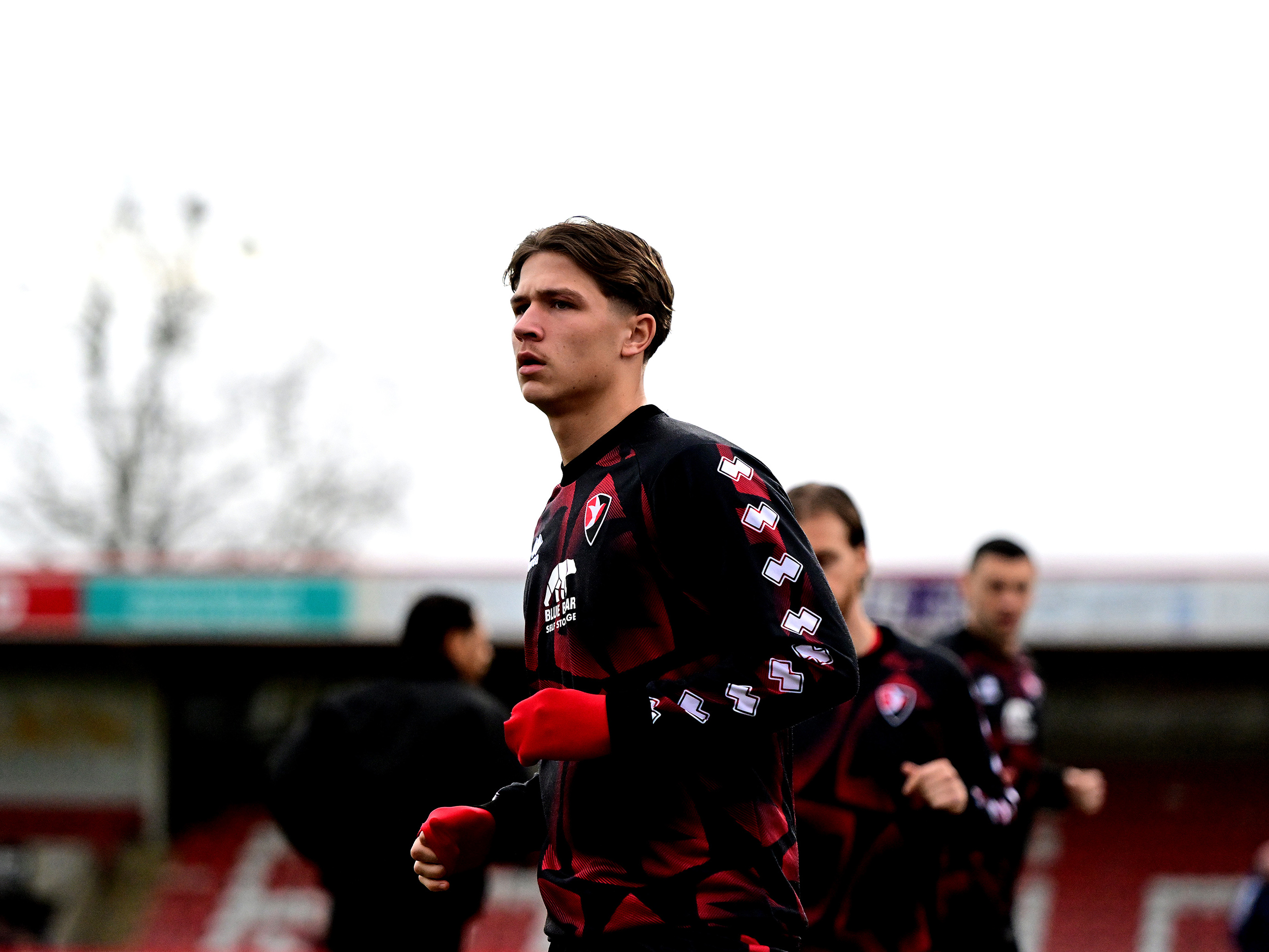 A photo of Cole Deeming warming up for loan club Cheltenham Town