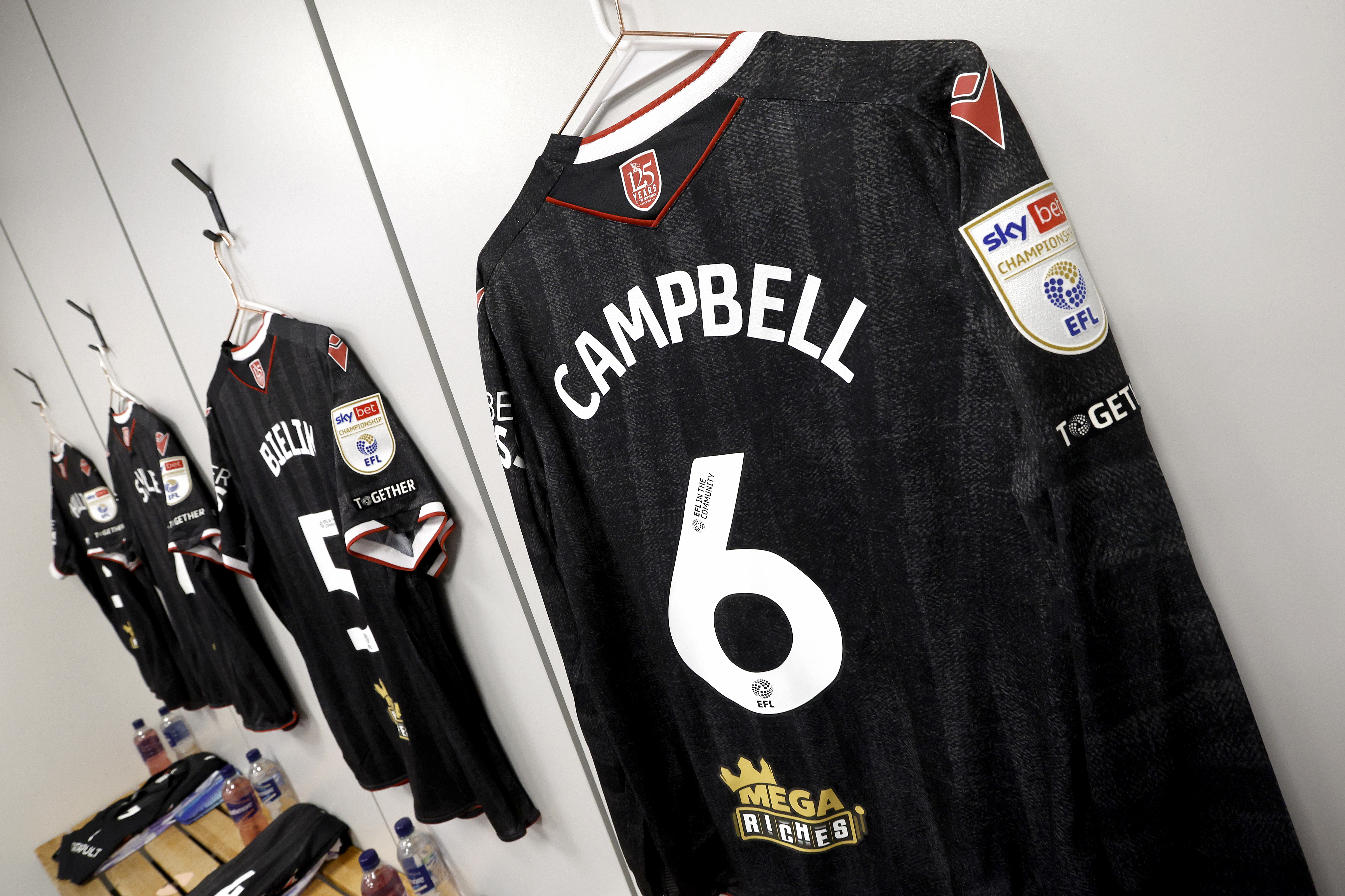 George Campbell's black away shirt hanging up in a changing room 