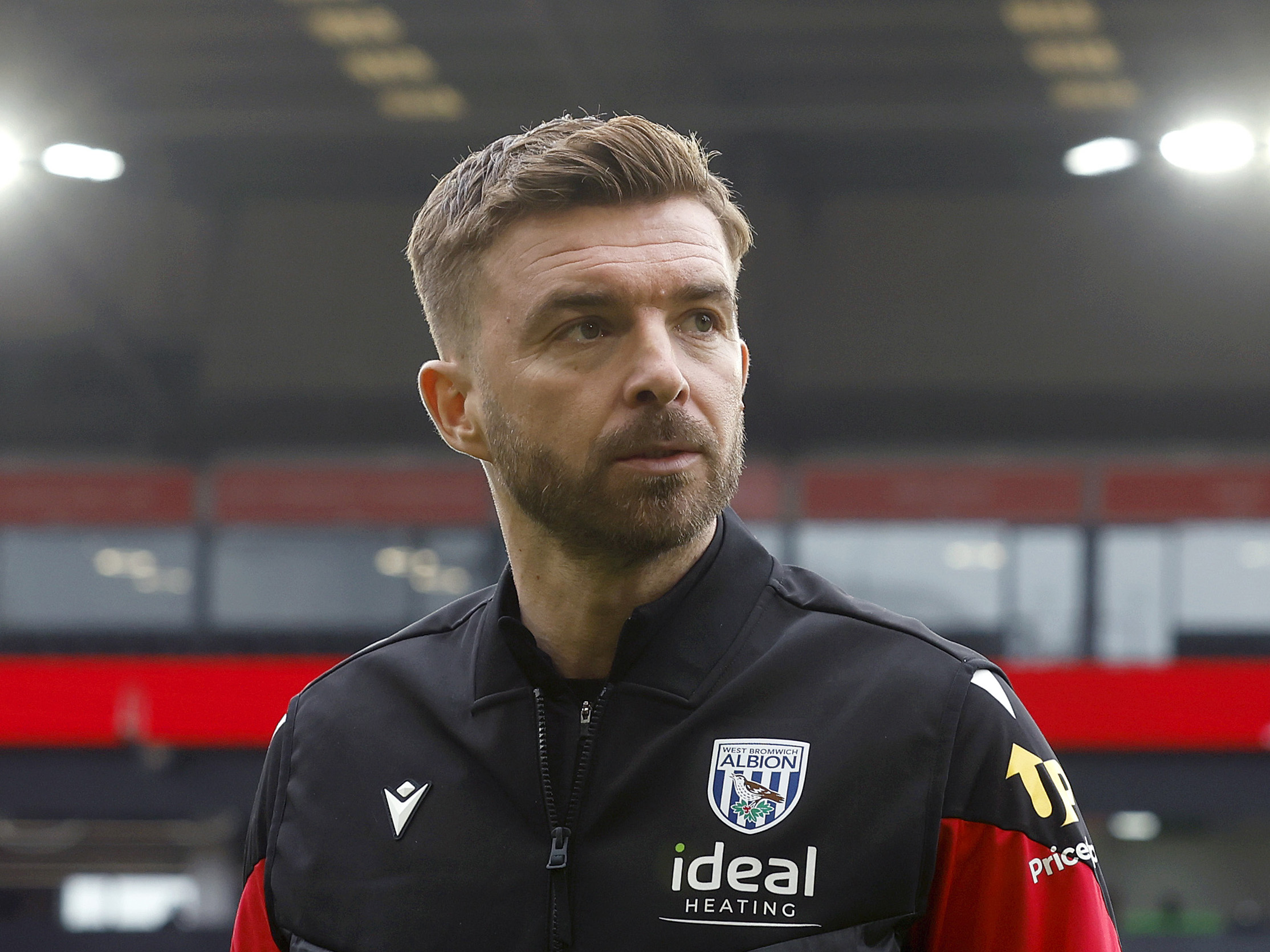 James Morrison looking to his left in a WBA tracksuit 