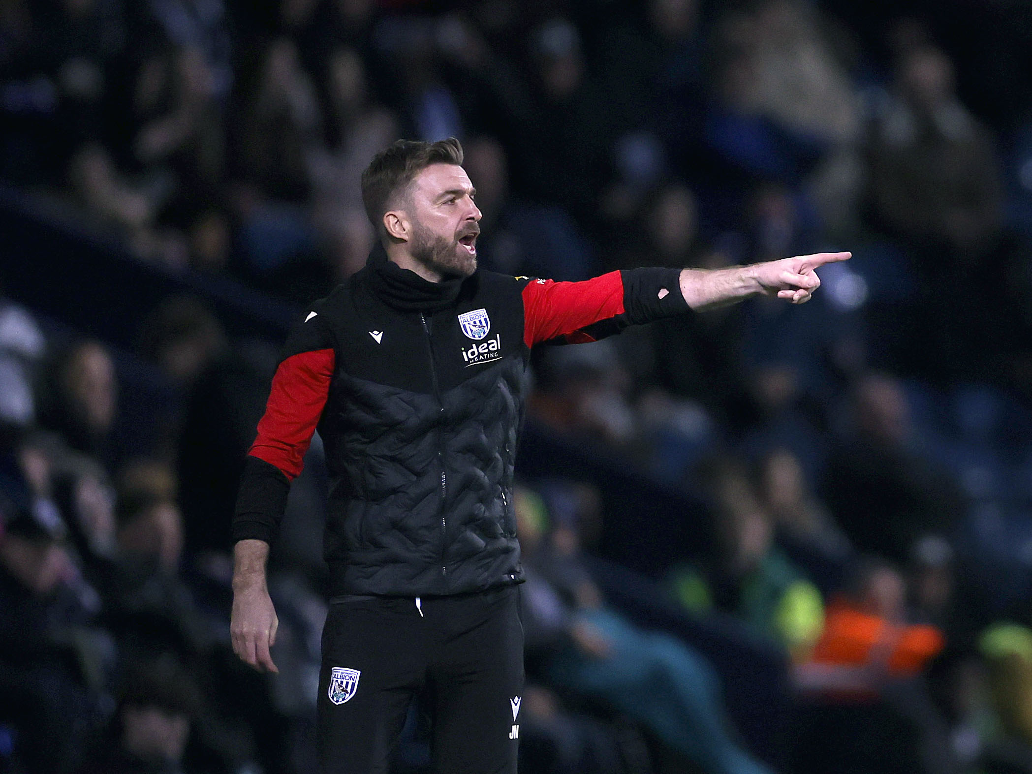 James Morrison giving instructions to players and pointing during a game