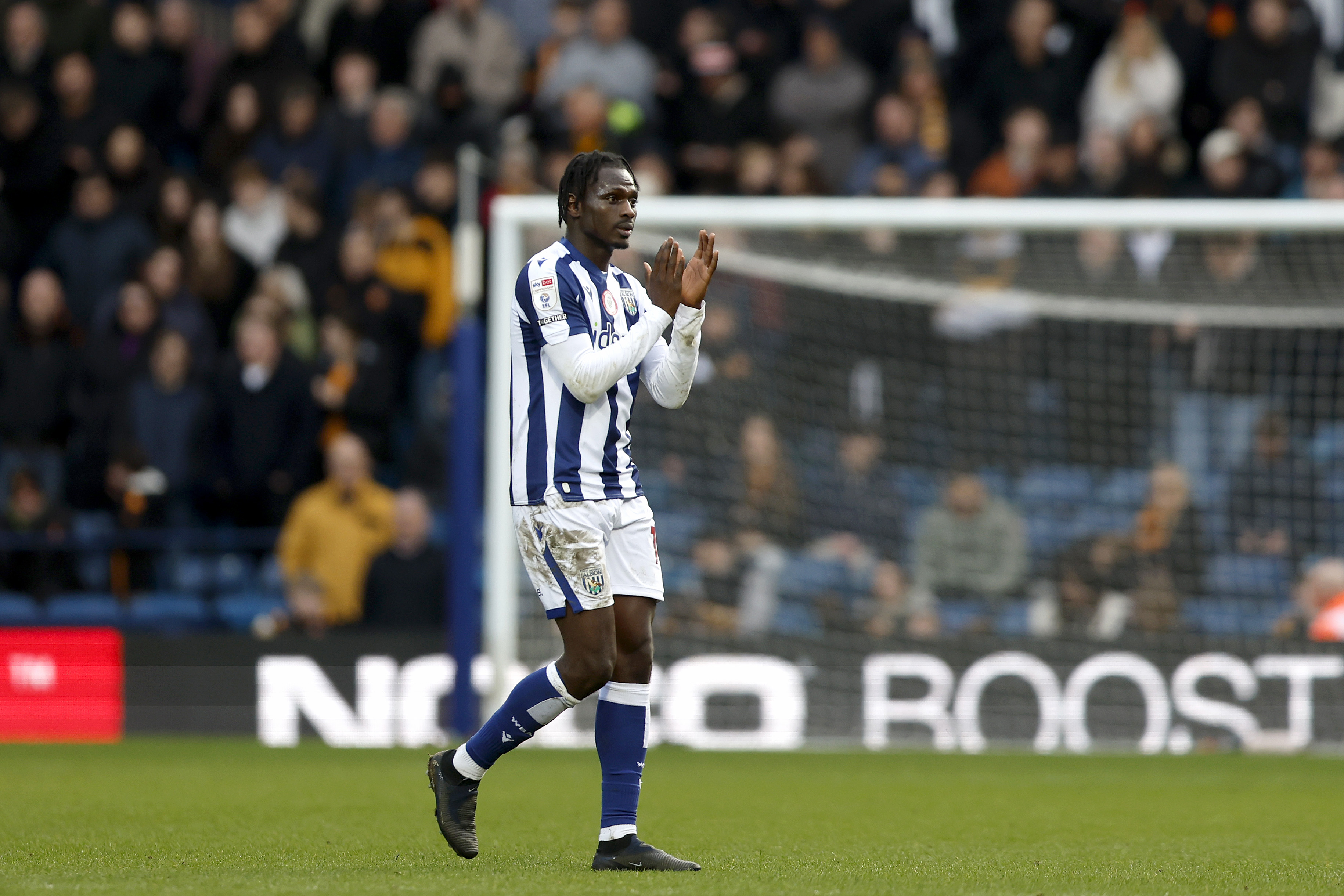 Ousmane Diakité applauding WBA fans in the home kit 
