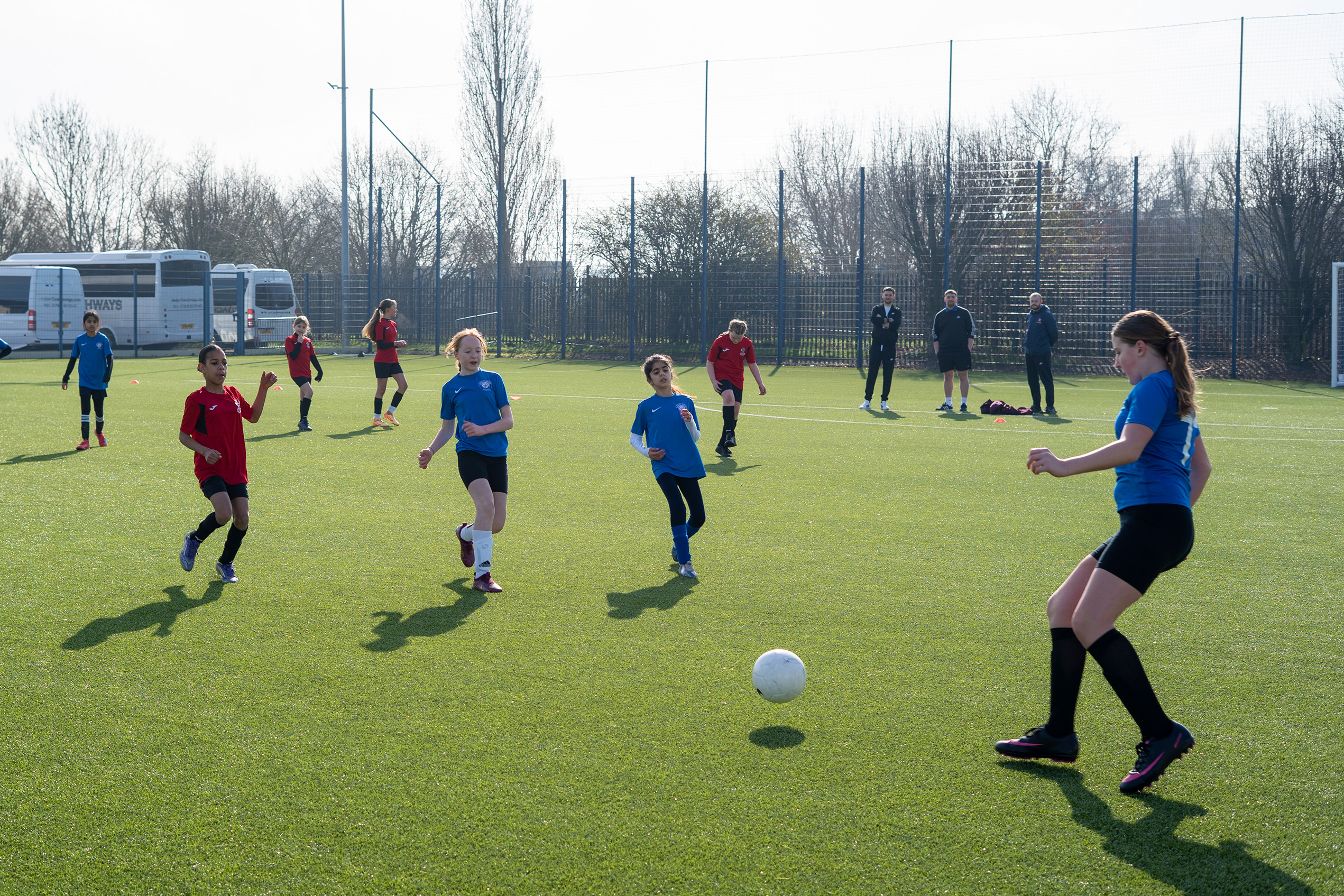 Players competing outside on the Academy 4G pitch.