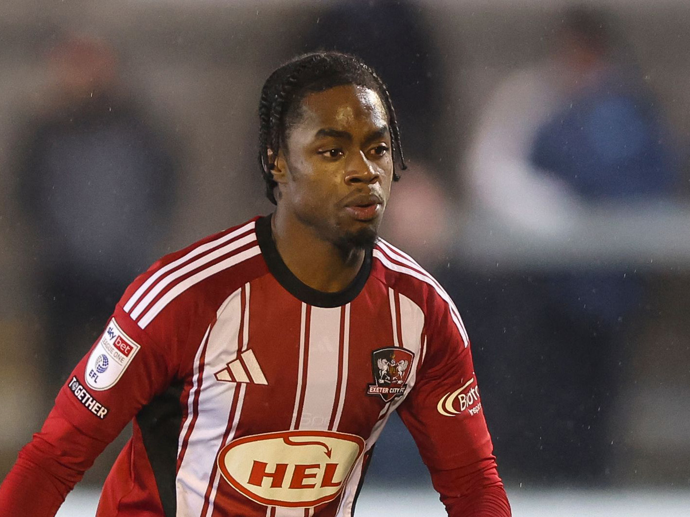 Akeel Higgins in action for Exeter City in their home kit 