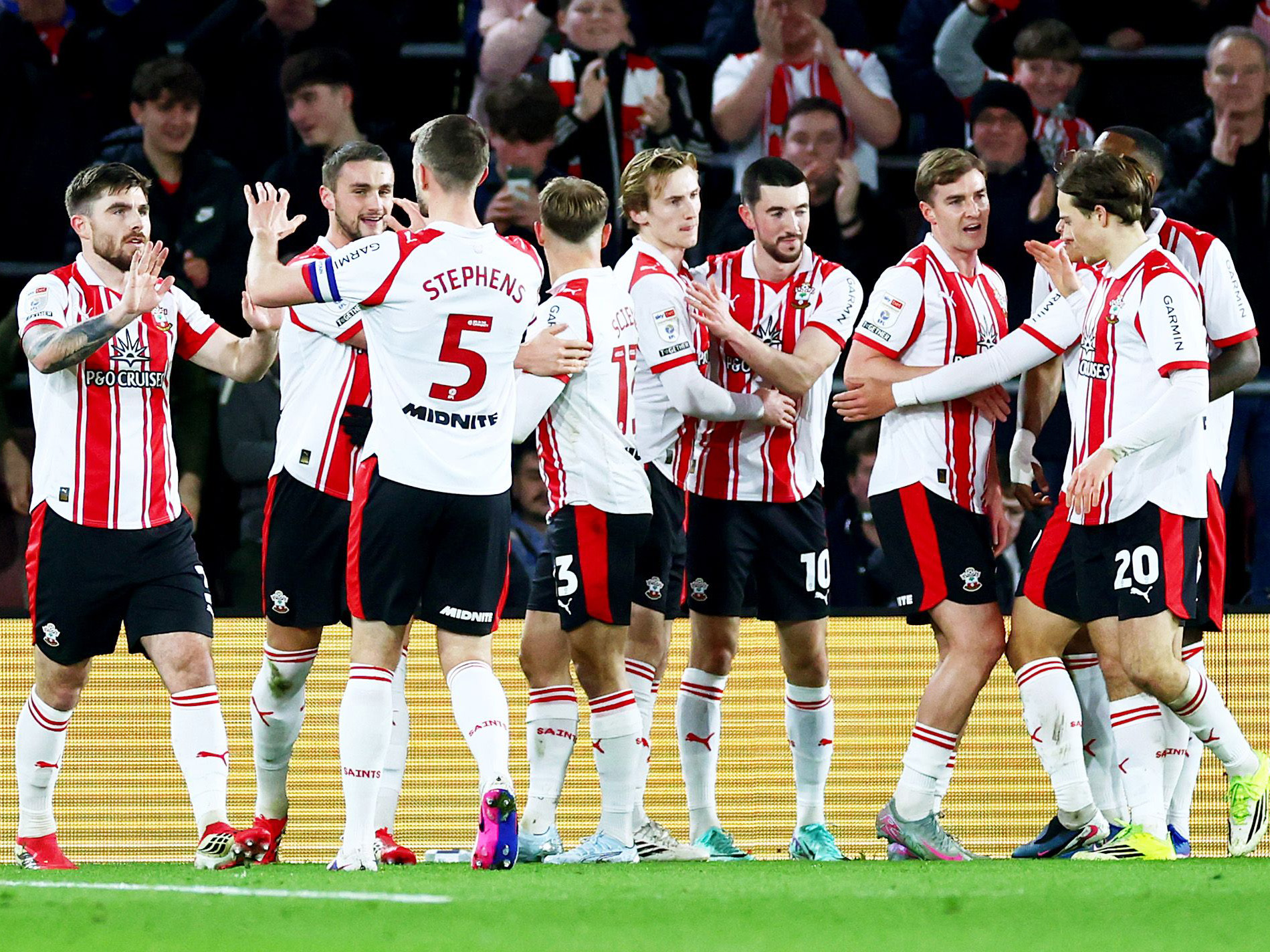 Several Southampton players celebrate a goal in their home kit 