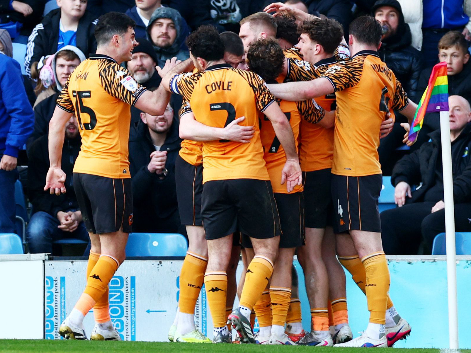 Several Hull City players celebrate a goal scored in their home kit 