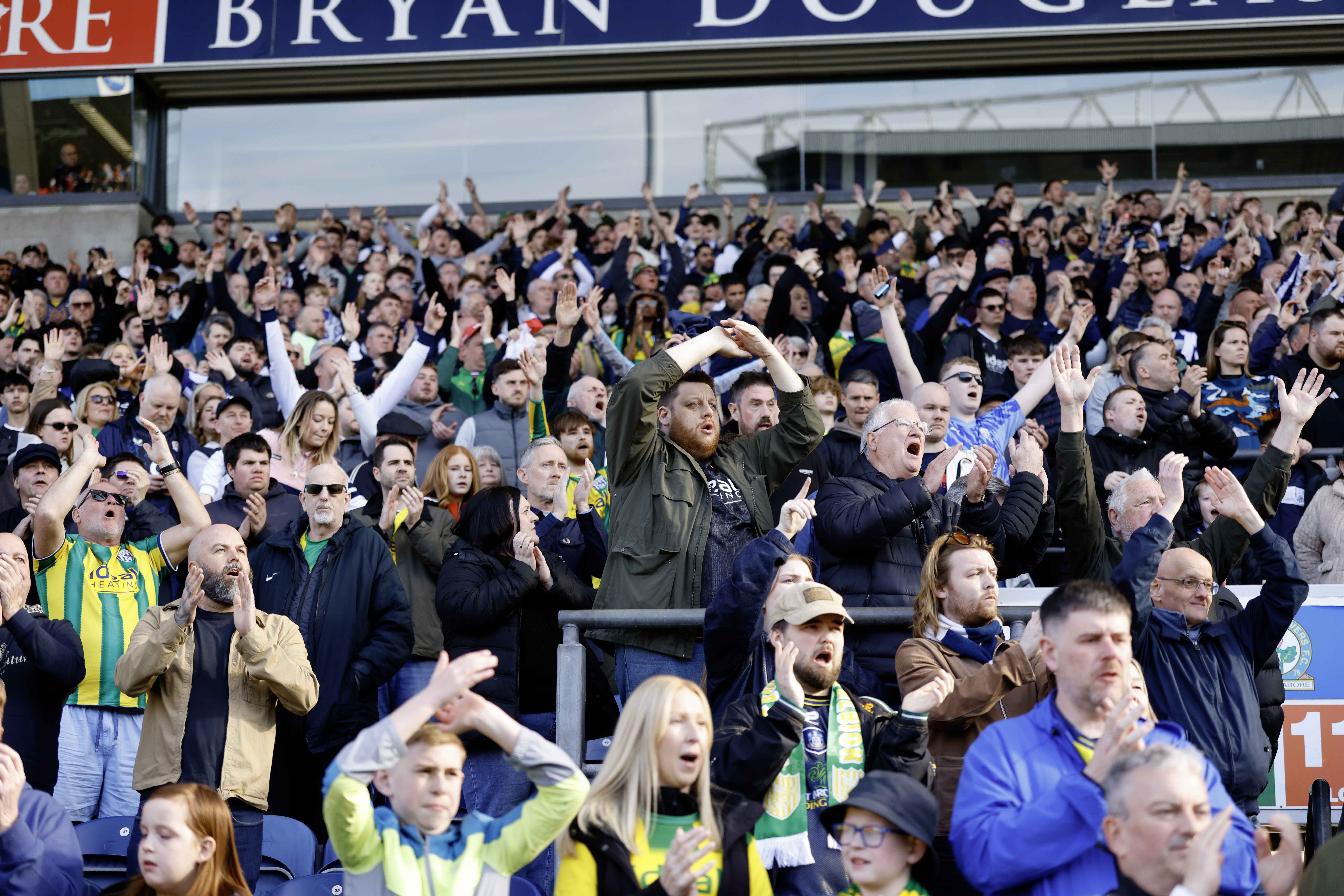 A general view of several WBA fans cheering at a game 