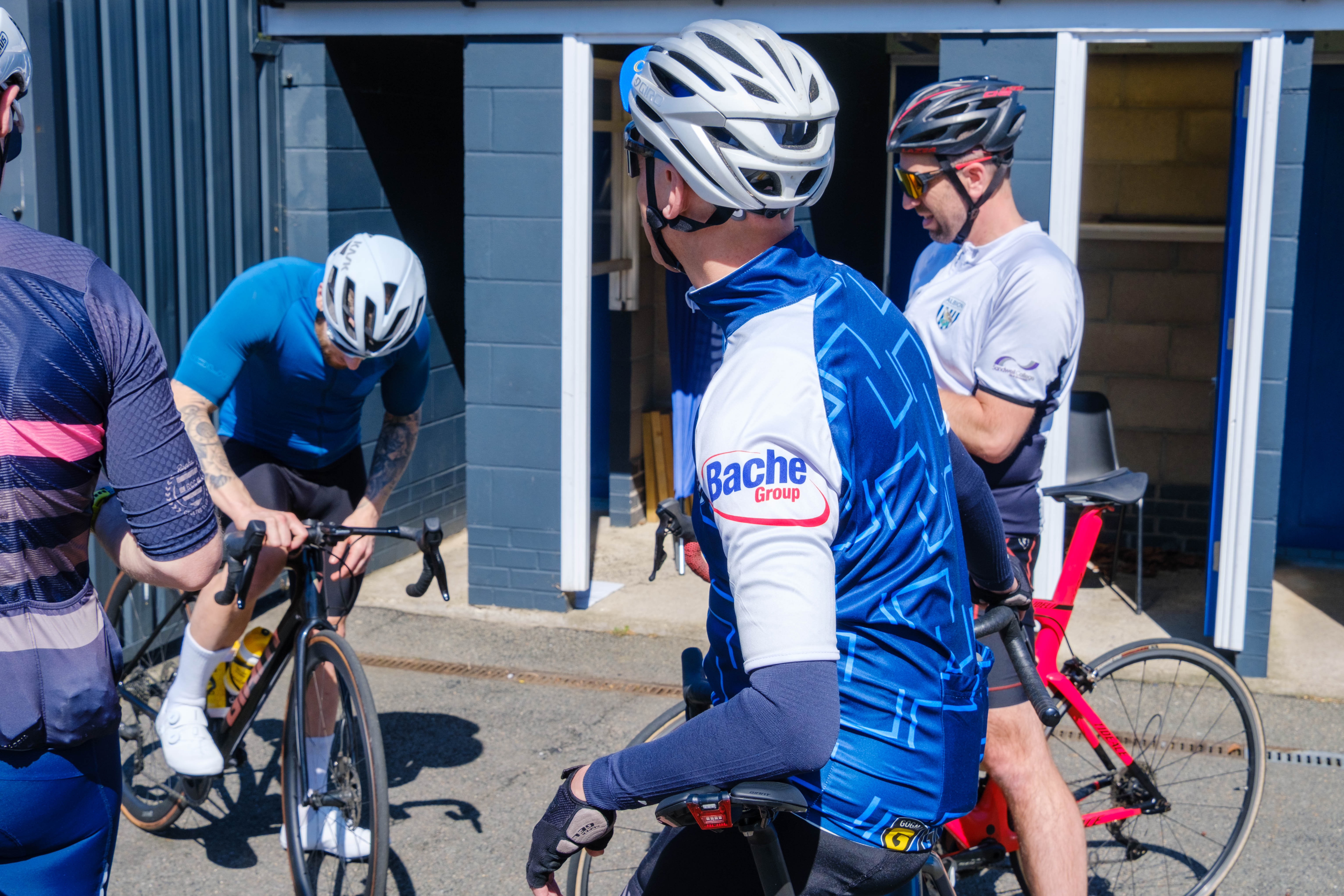 Cyclists relaxing before starting the first leg.