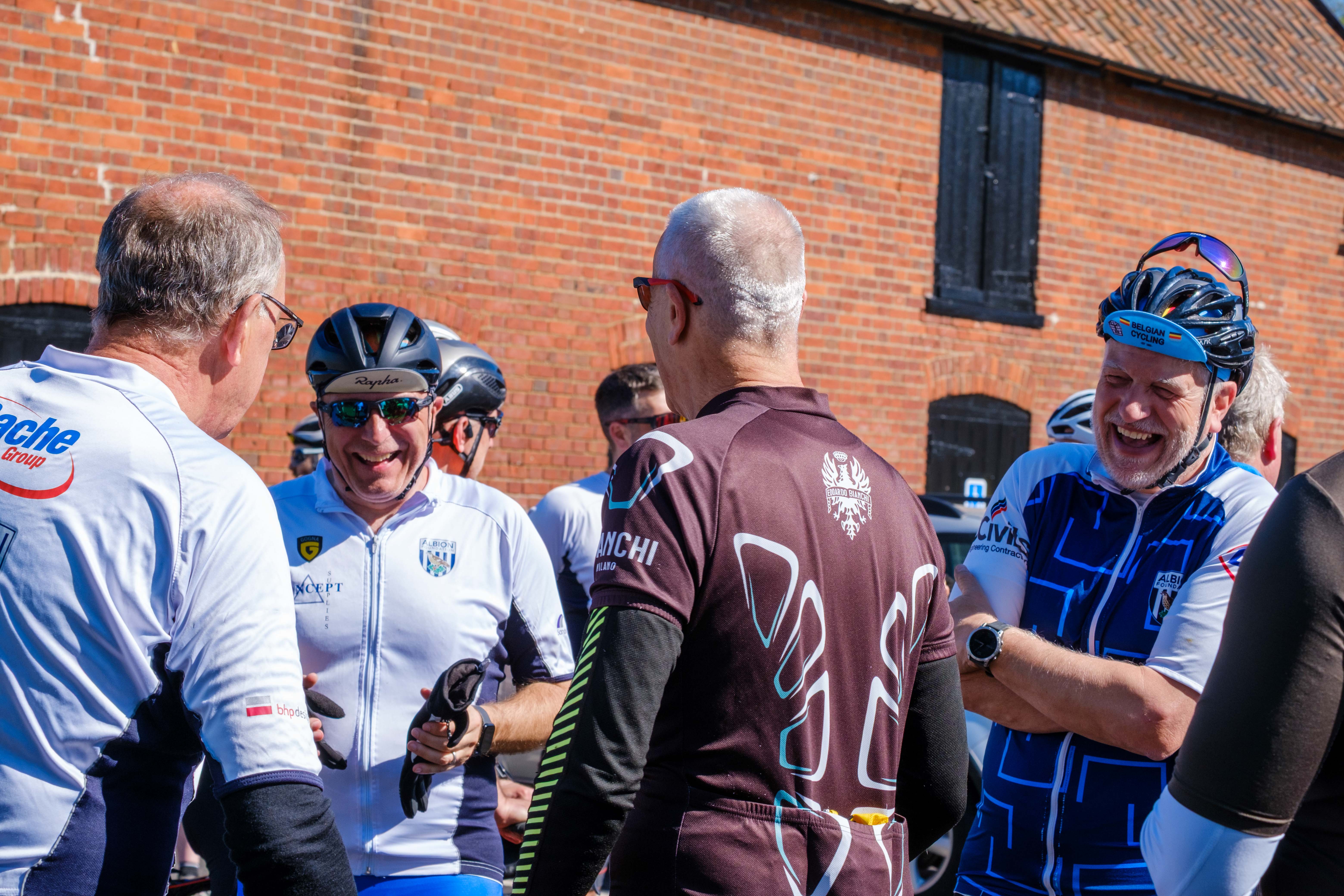 Cyclists laughing at a meeting stop.