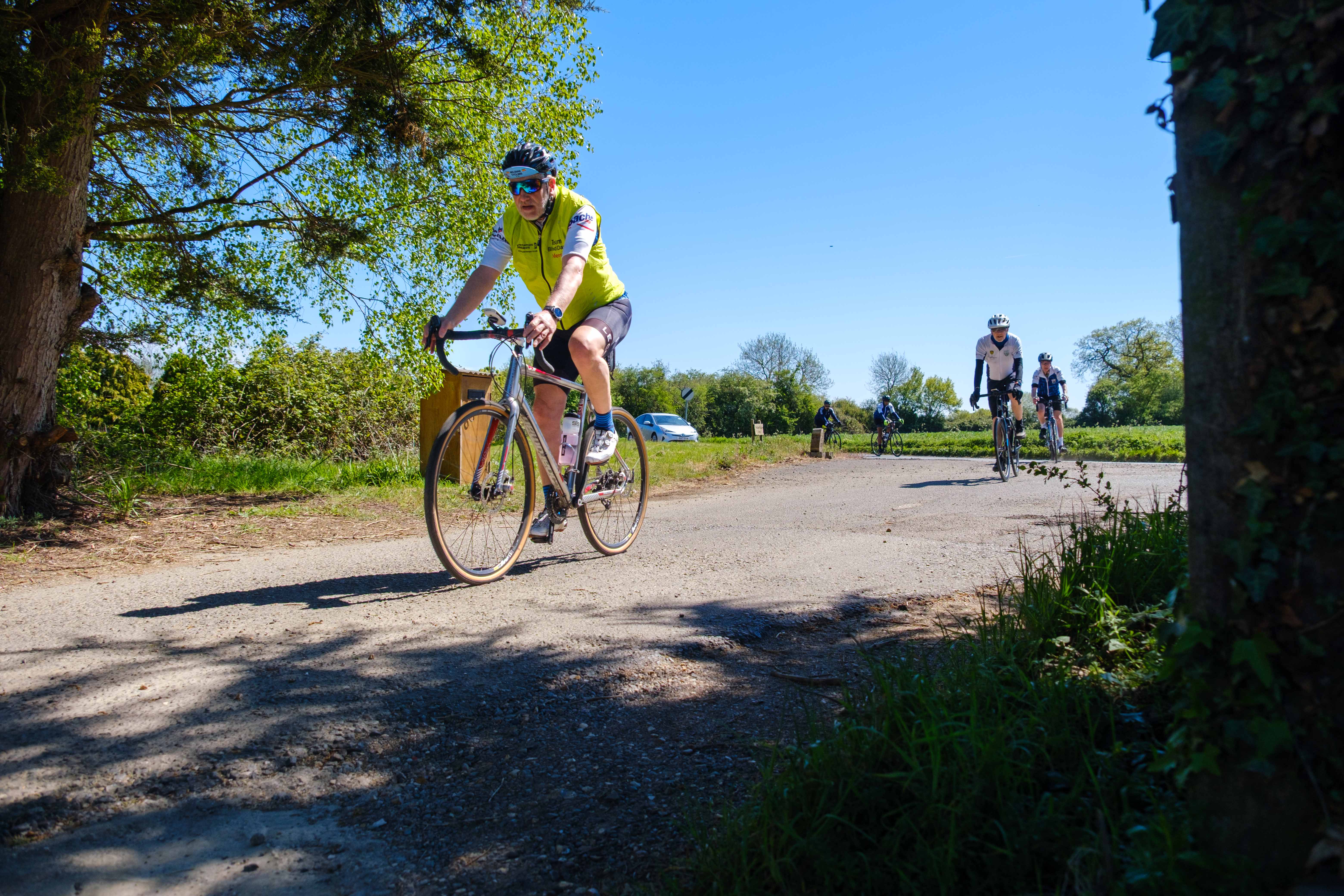 Steve Meeson riding down a country road.
