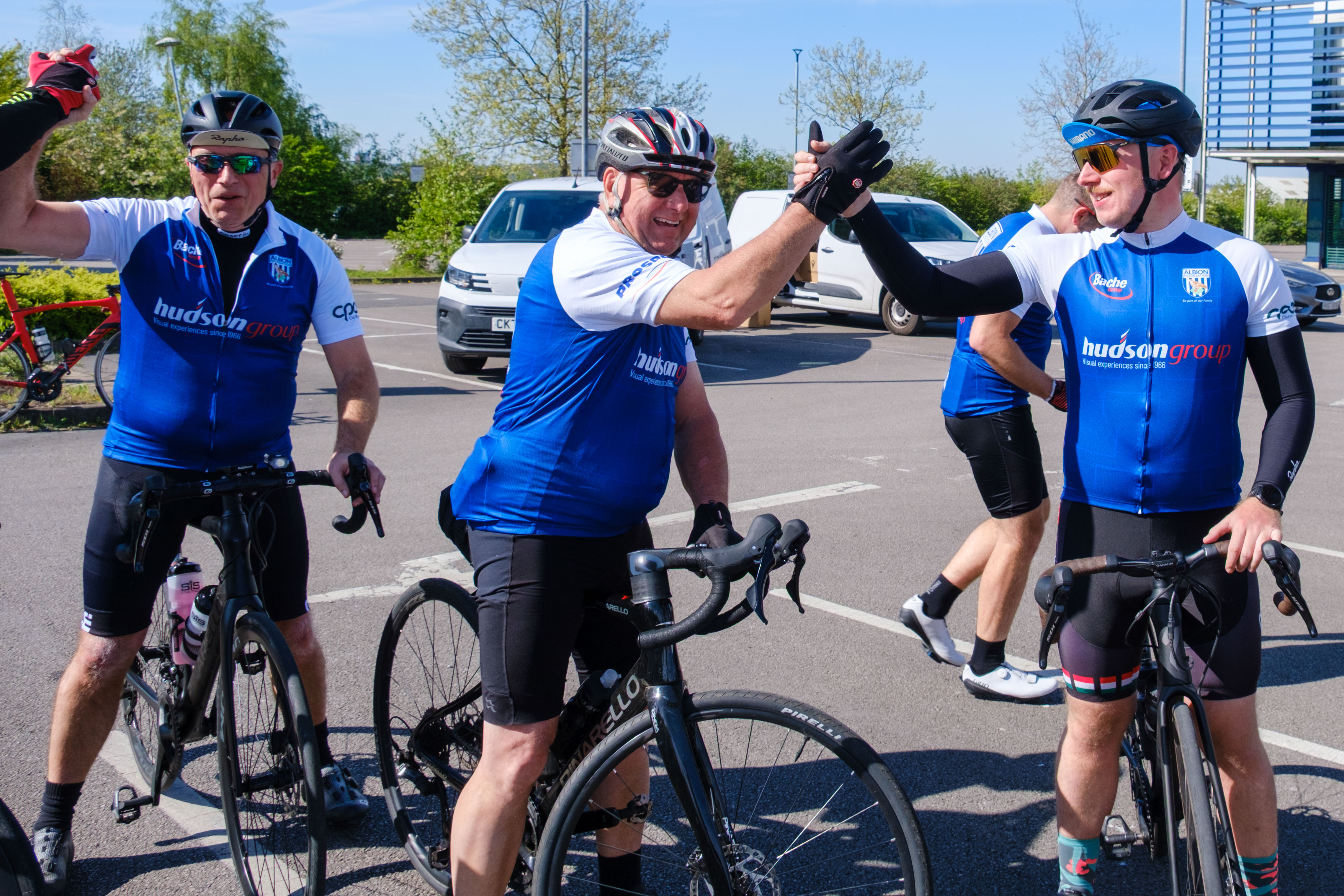 Cyclist shakes hands in delight.