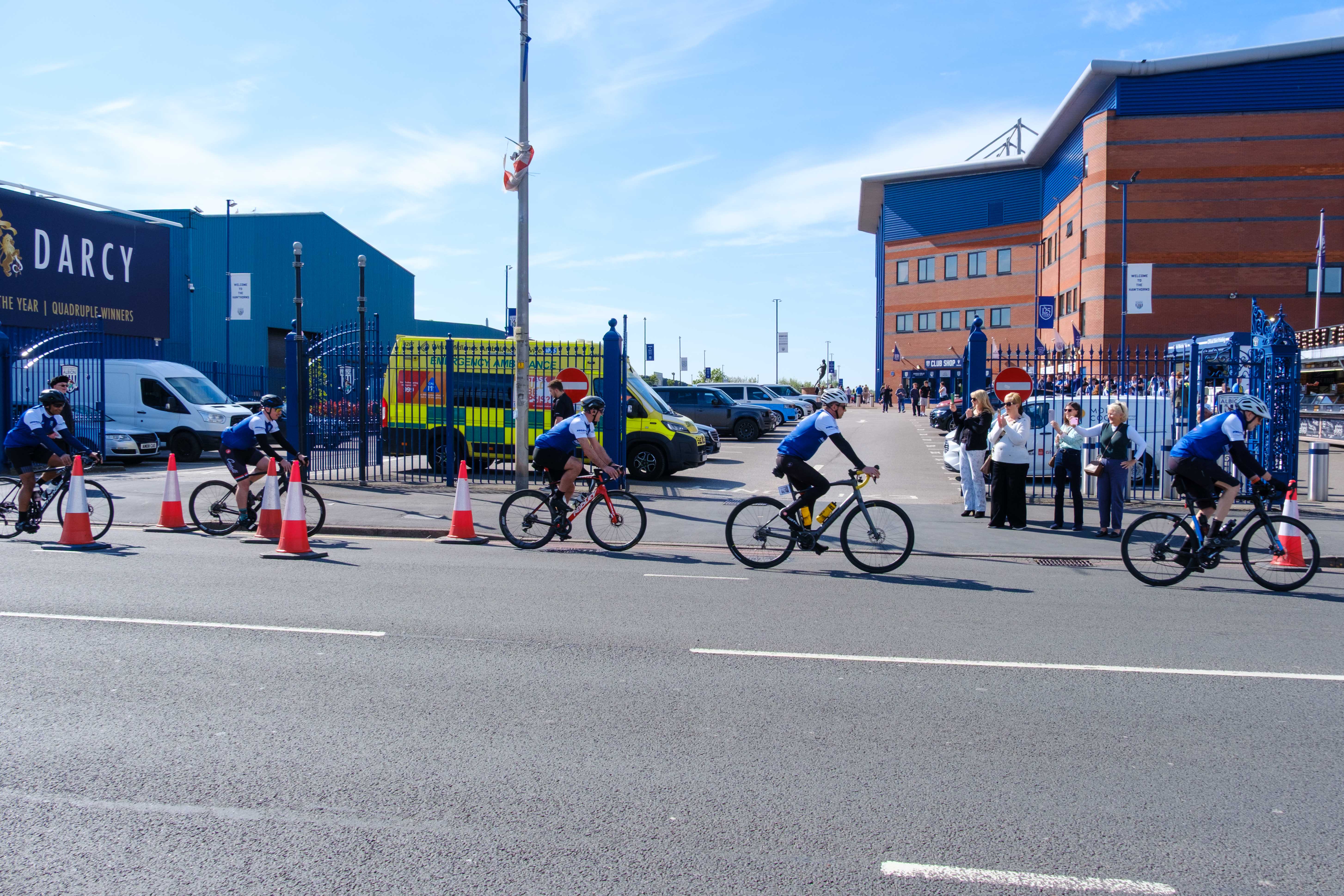 Cyclist riding place the gates of the East Stand.