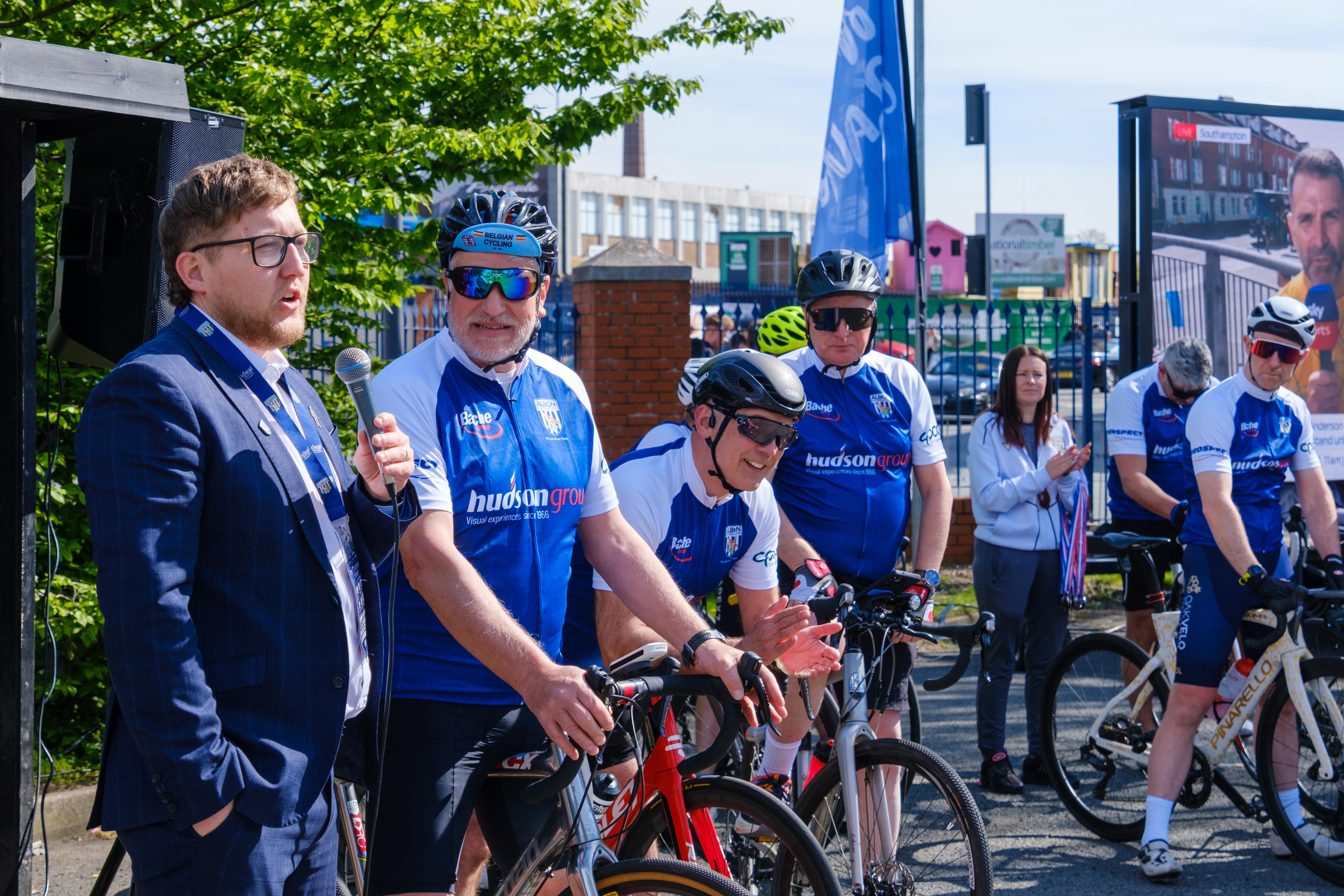 Deputy Director Jon Ward interviewing cyclists in the fanzone.