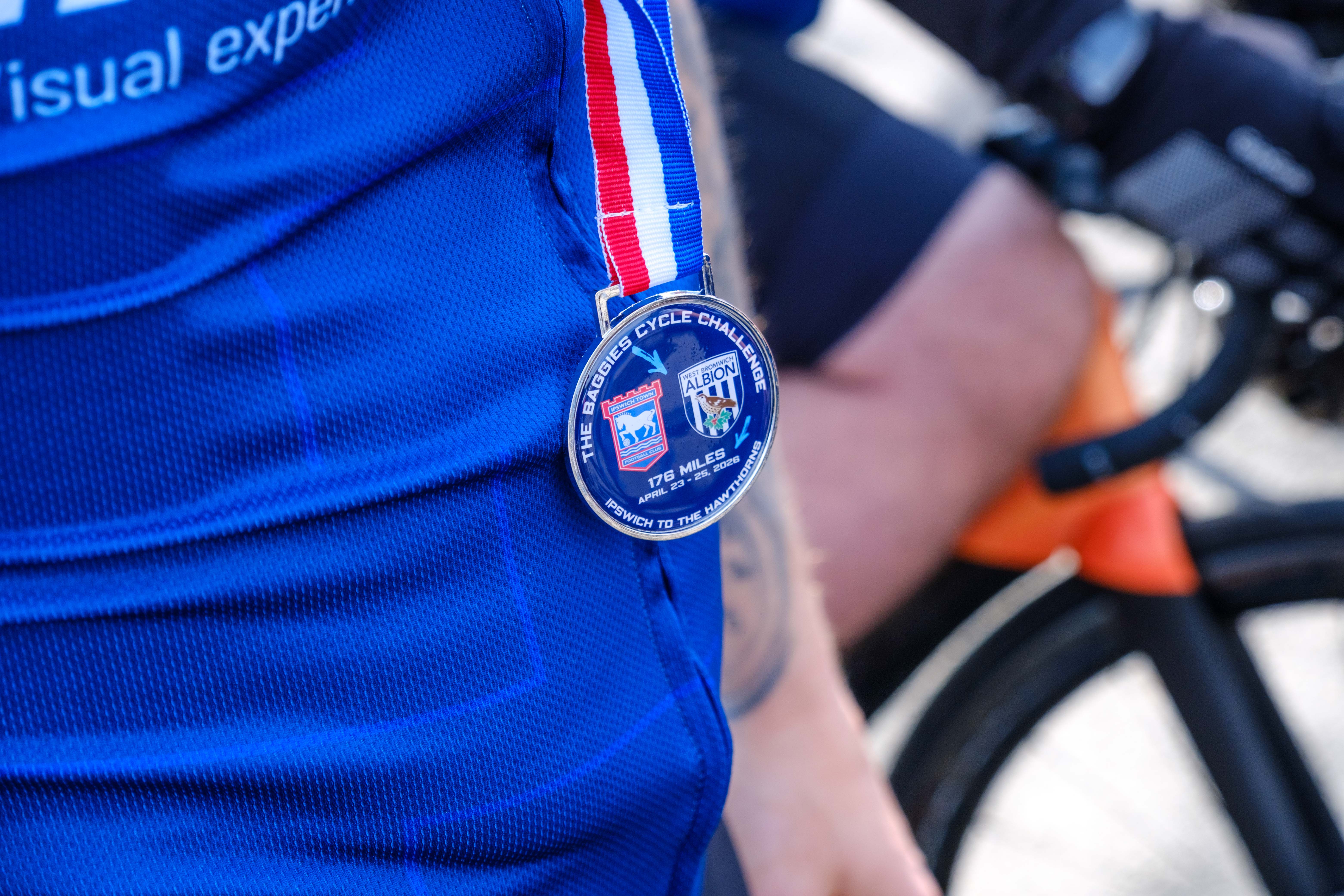 Close-up of cyclist's medal.