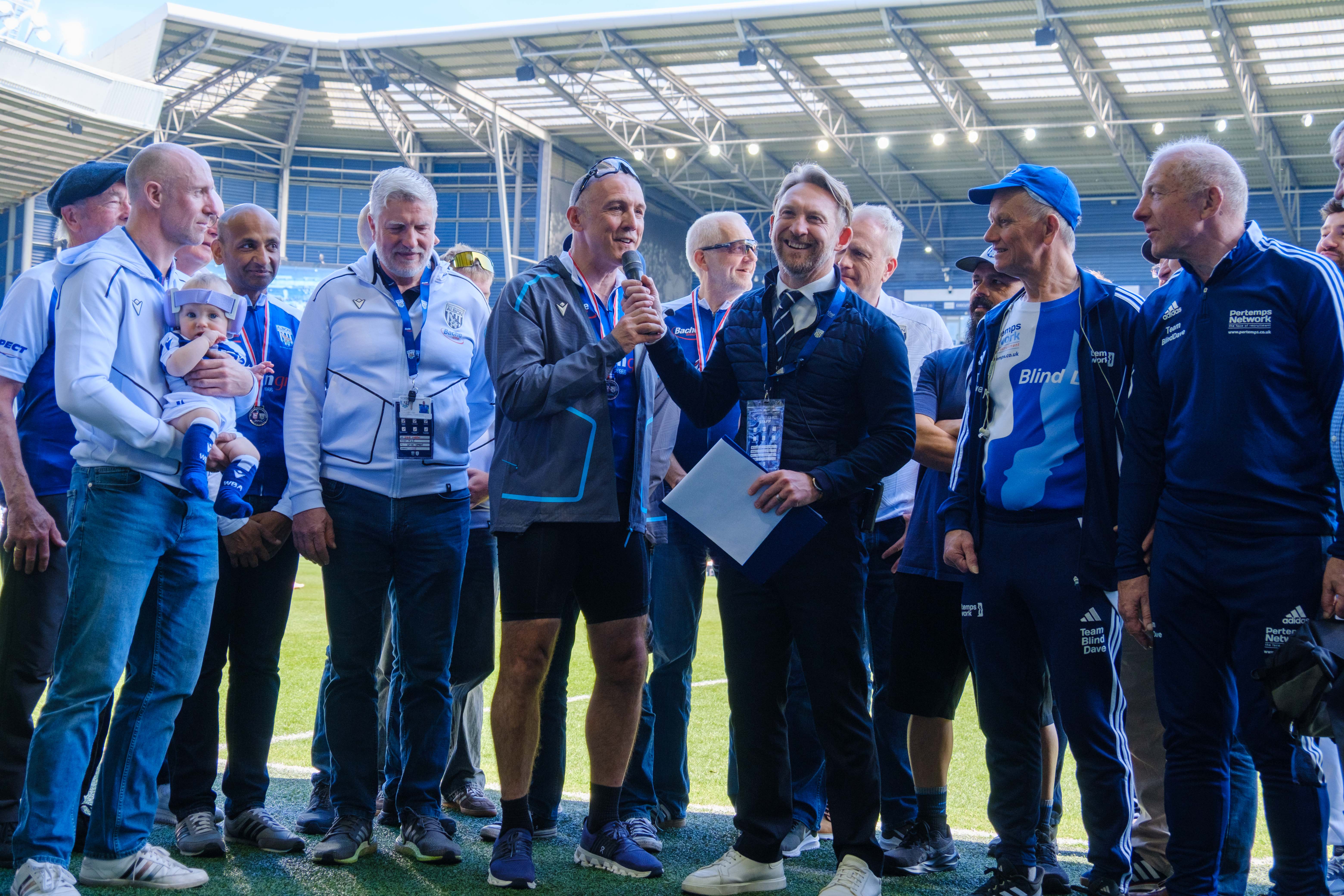 Paul Mardon and the cyclists being interview by Hursty pitch side.