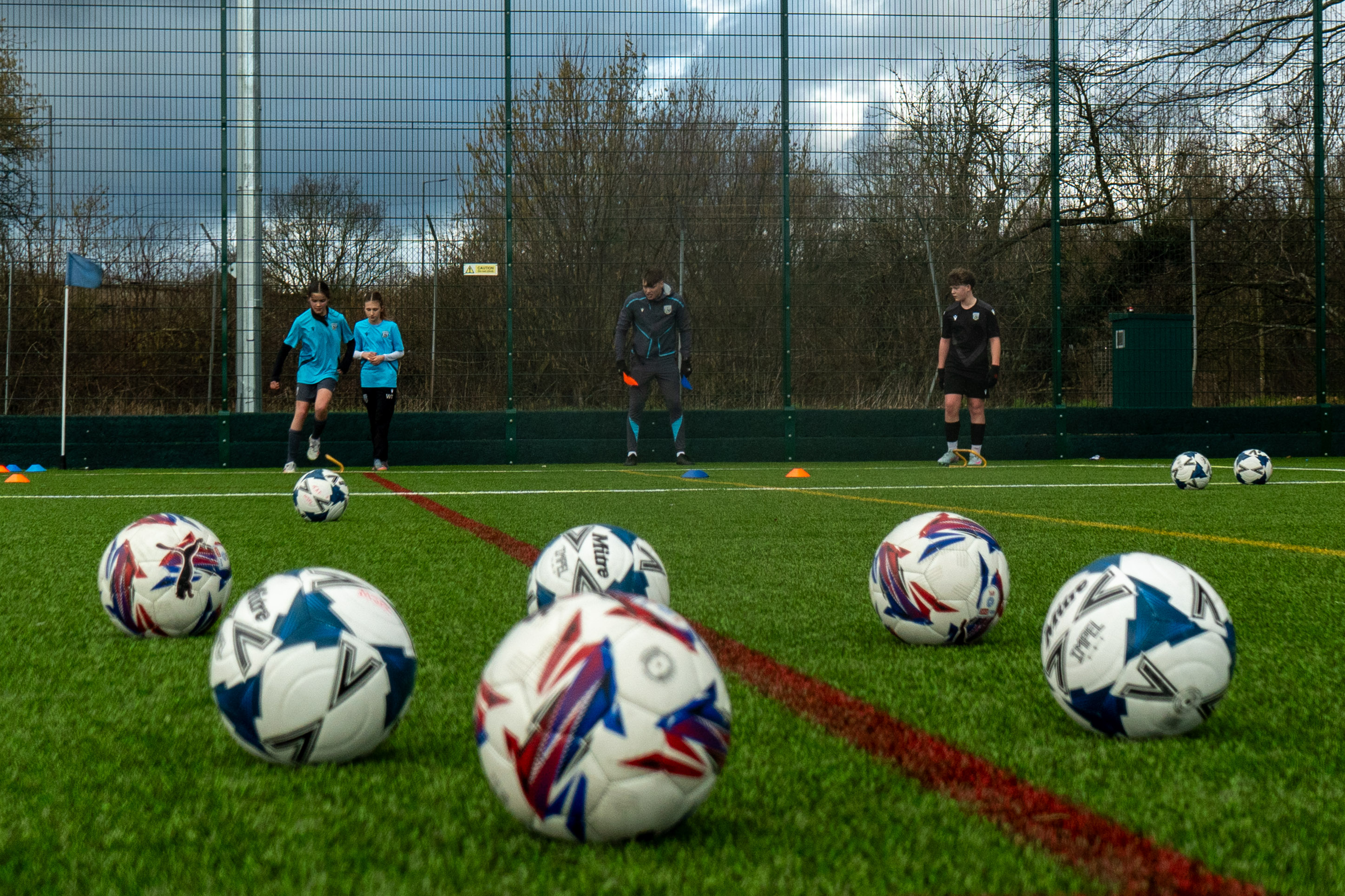 Participants practicing a football drill