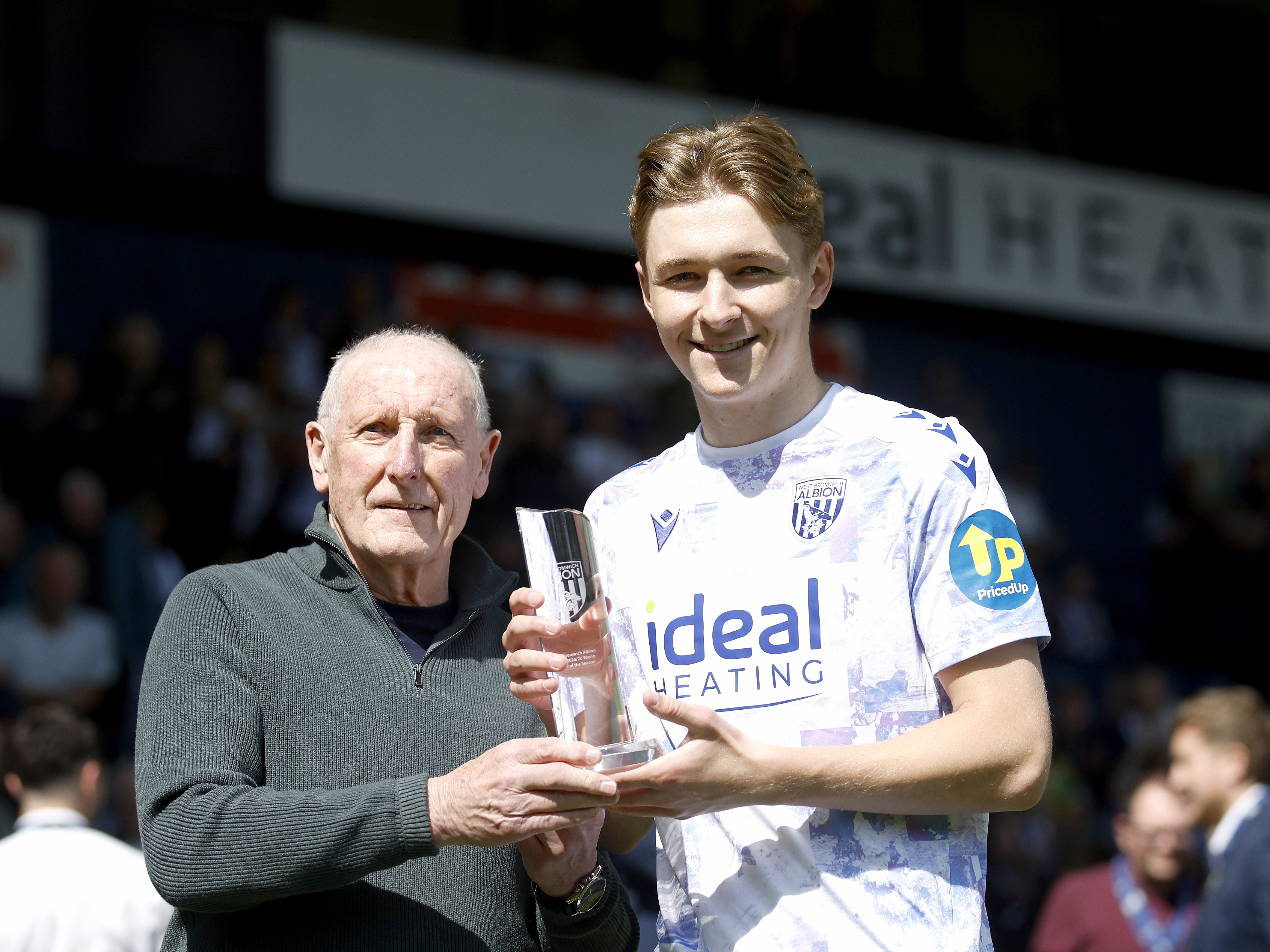 An image of Ollie Bostock with his young player of the season trophy