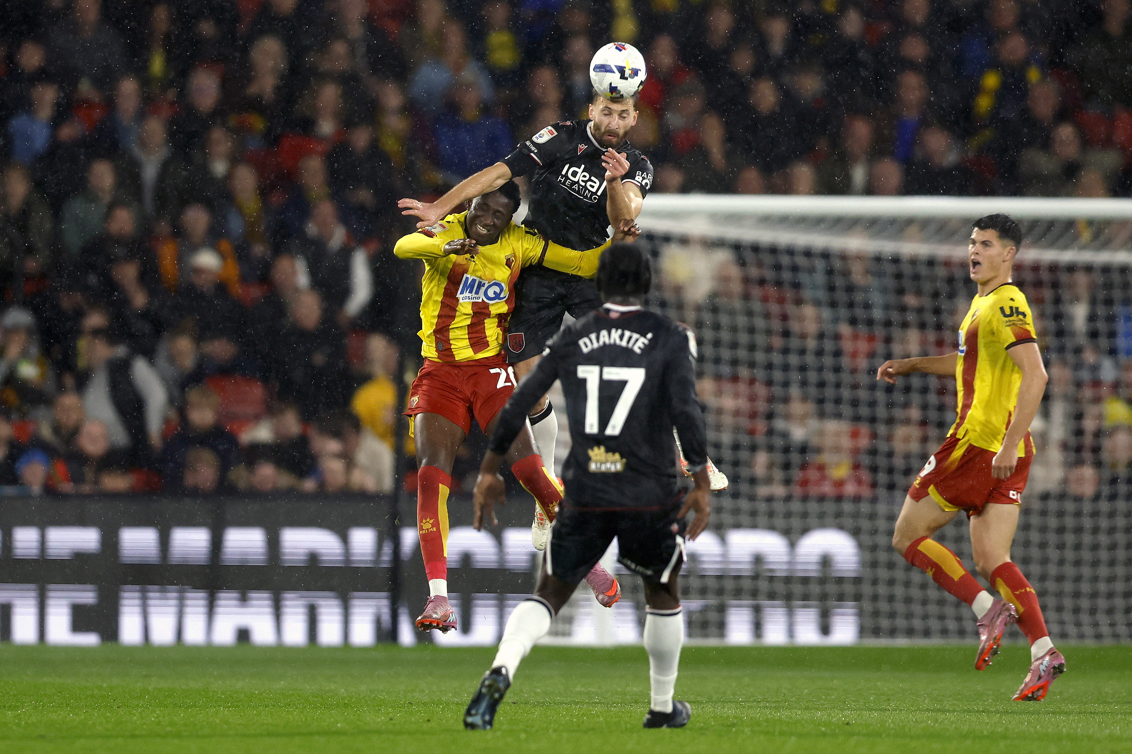 Nat Phillips winning a header against a Watford player 