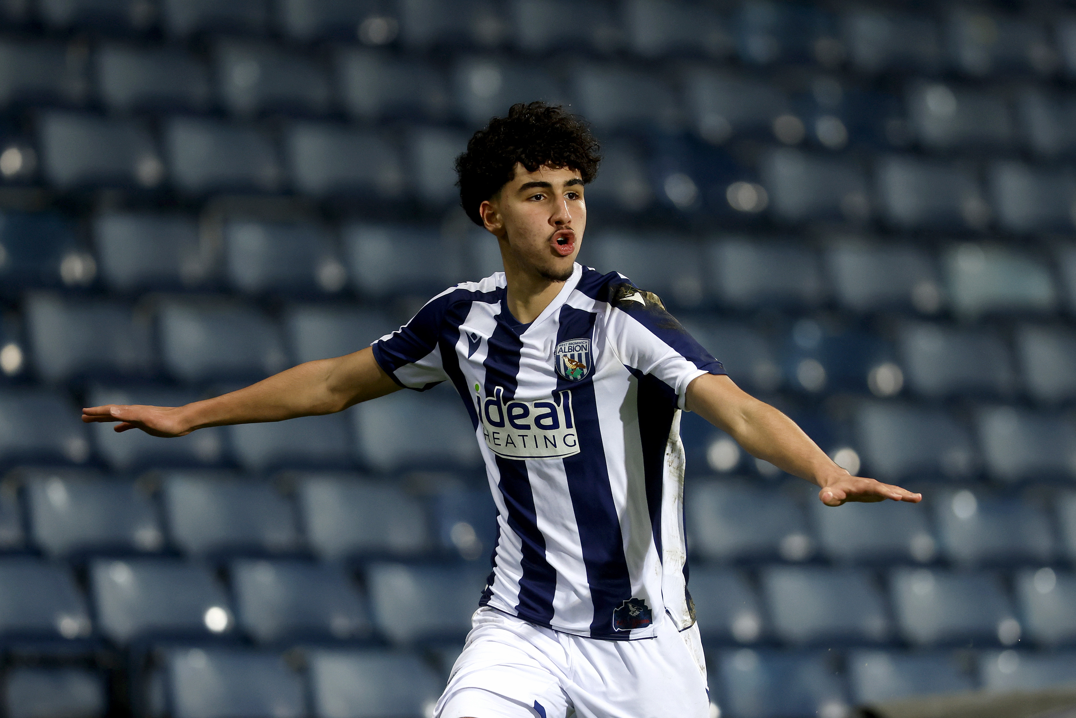 Adam Letlat celebrating a goal in the home kit at The Hawthorns