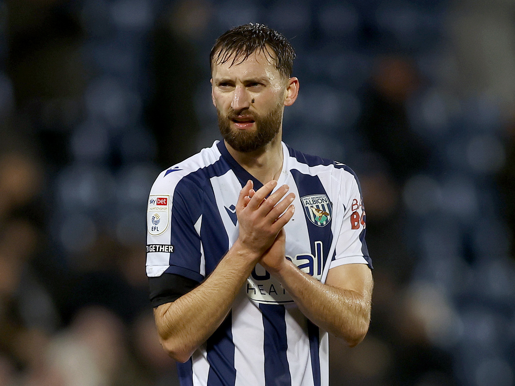 Nat Phillips applauding WBA fans in the home kit 
