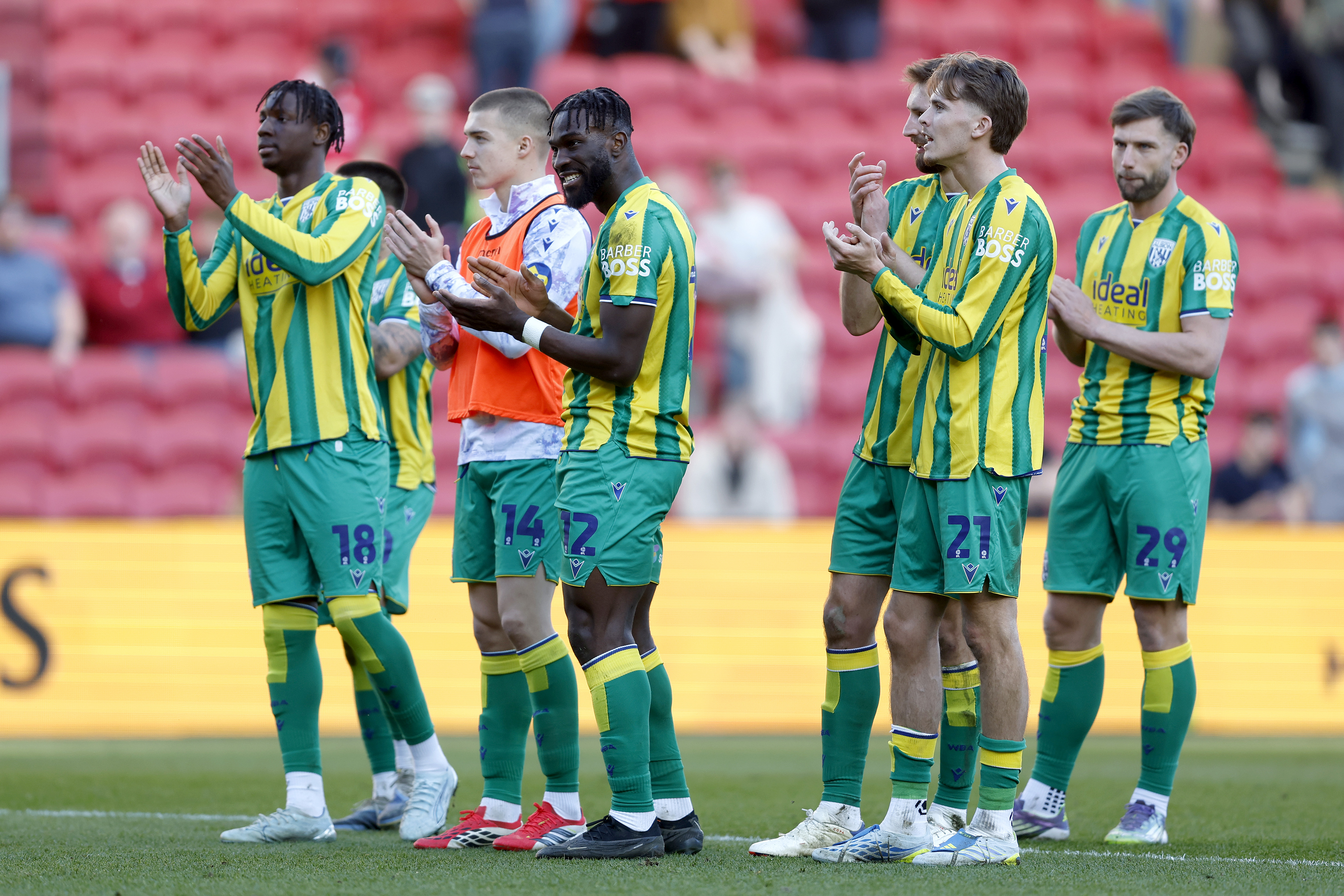 Several WBA players applauding supporters after the win at Bristol City in the green and yellow away kit 