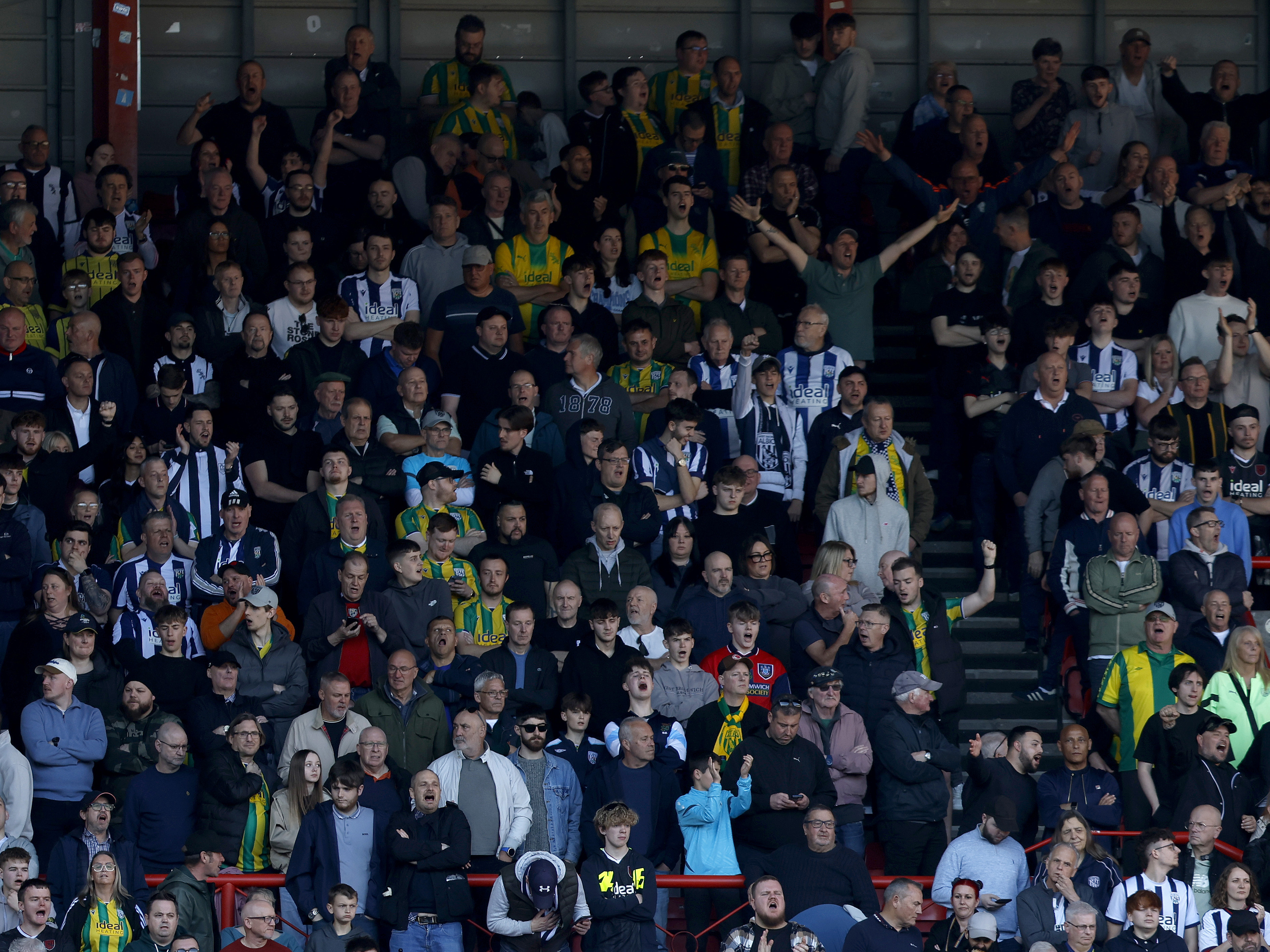 A general view of several WBA fans in a stand at a game 