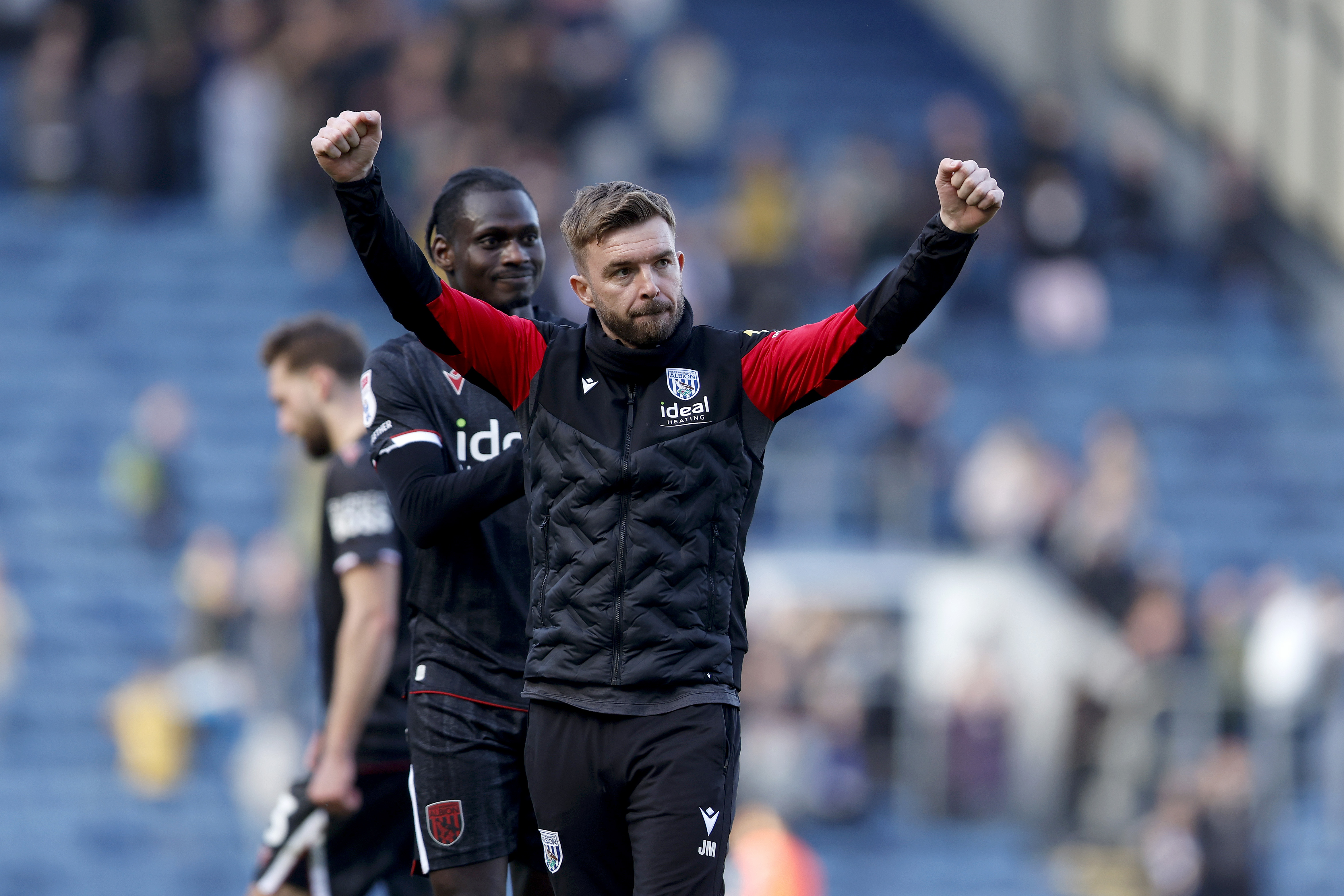 James Morrison cheering on the pitch with Ousmane Diakité behind him