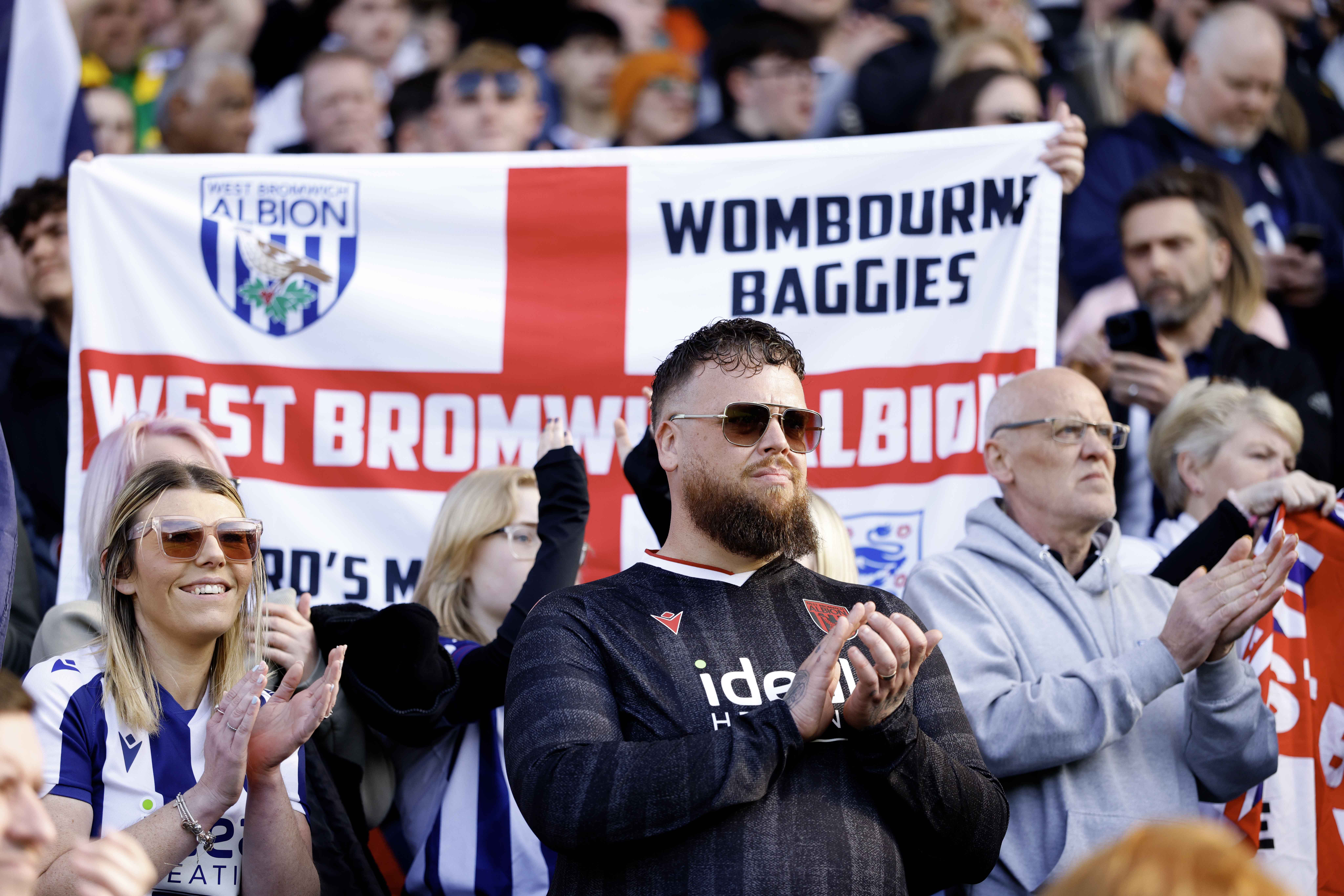 A general view of WBA fans in the stand with an England flag with a WBA badge on