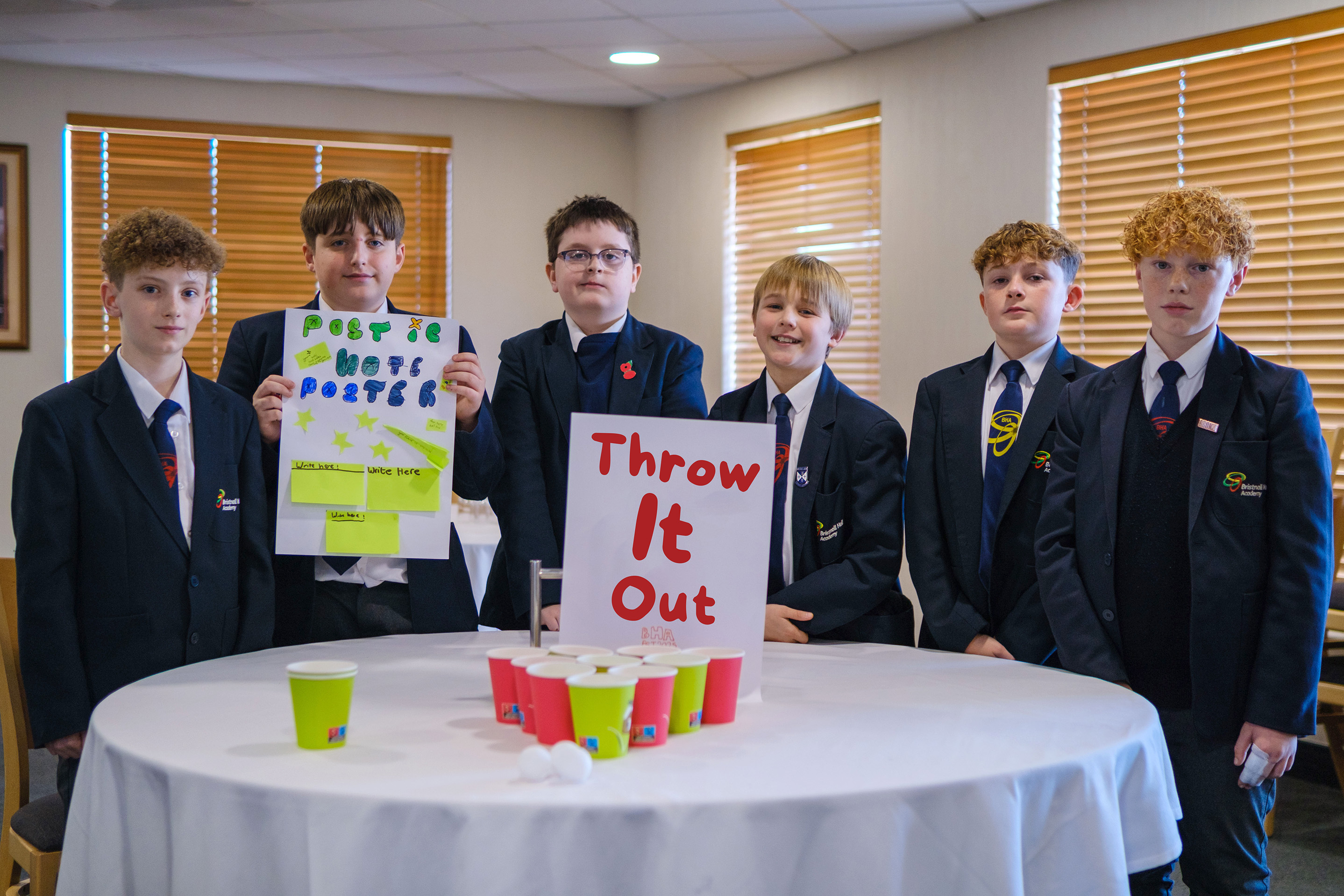 Bristnall Hall students in the Pennington Suite at The Hawthorns holding up Throw It Out flyers