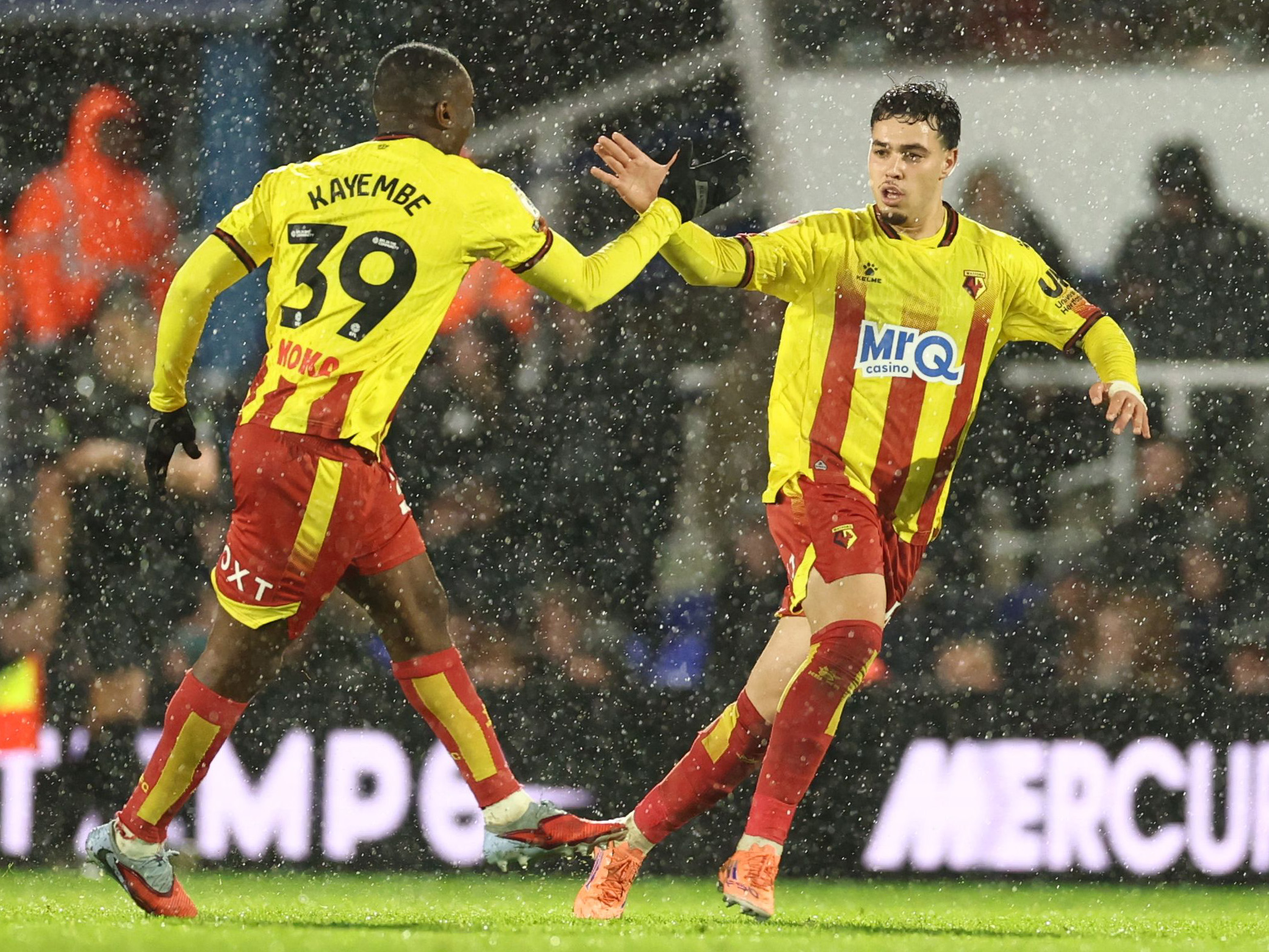 Edo Kayembe and Othmane Maamma celebrate a goal for Watford in their home kit 