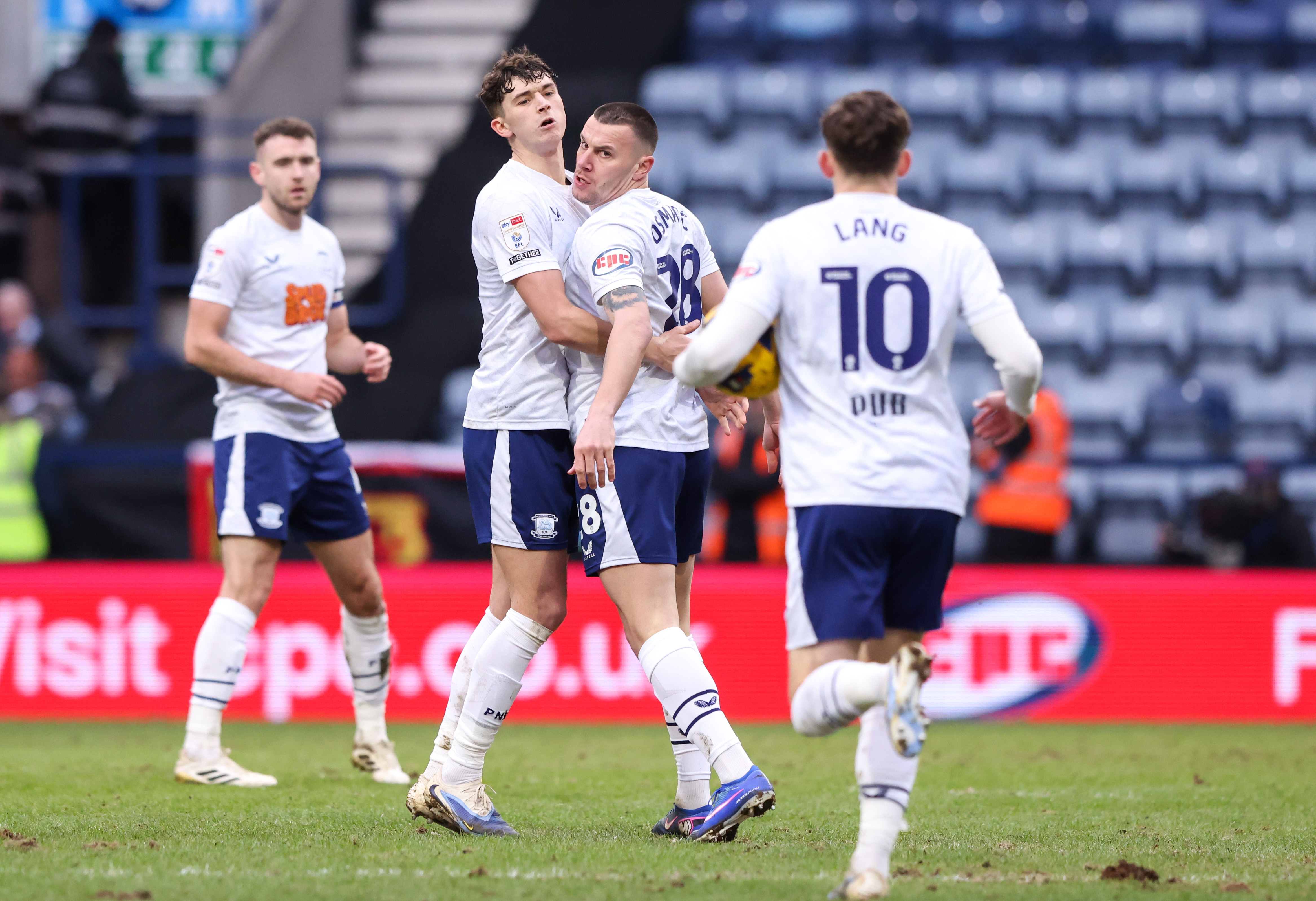 Four PNE players celebrate a goal scored in their home kit at Deepdale 