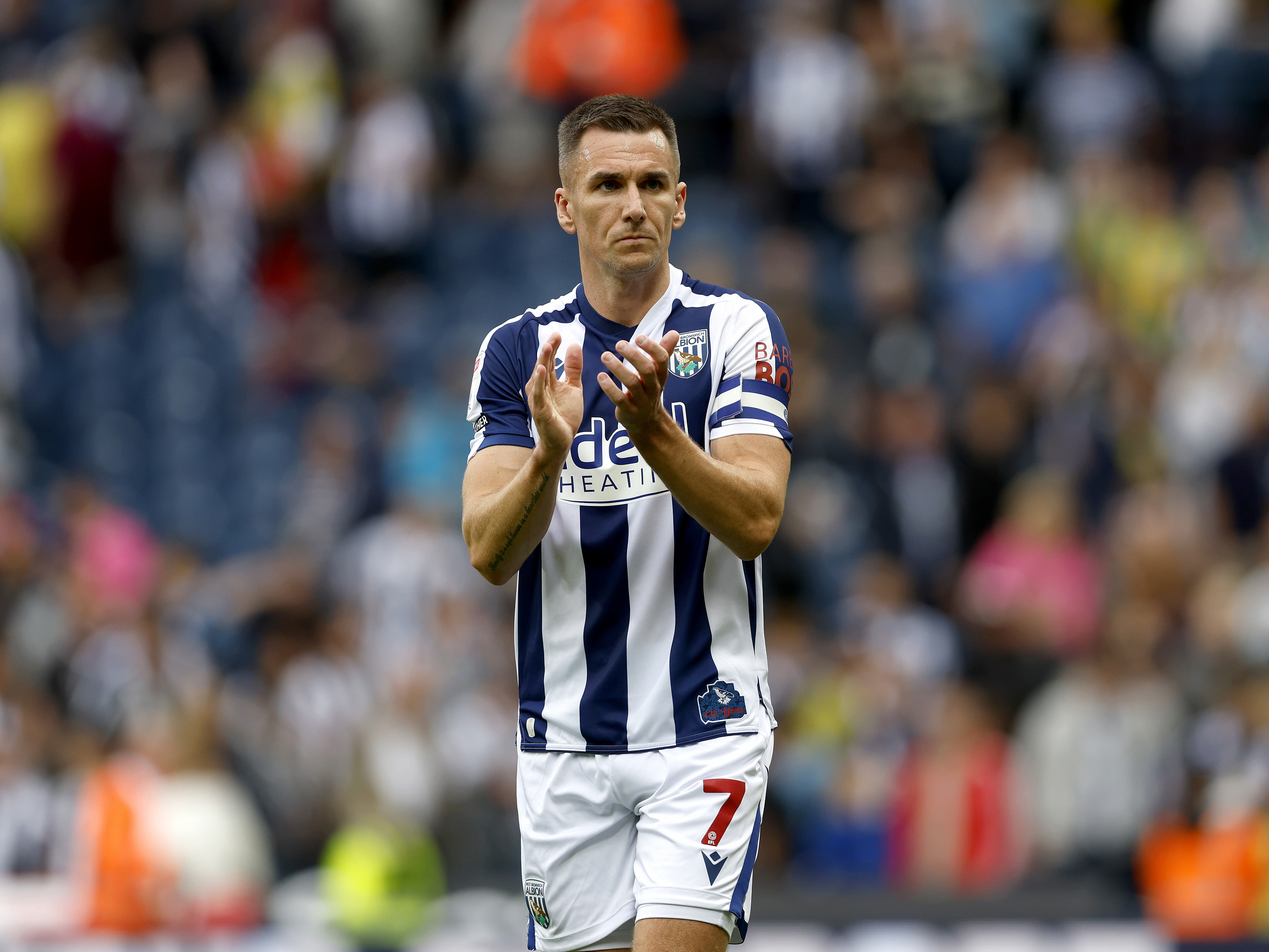 An image of Jed Wallace applauding Albion fans