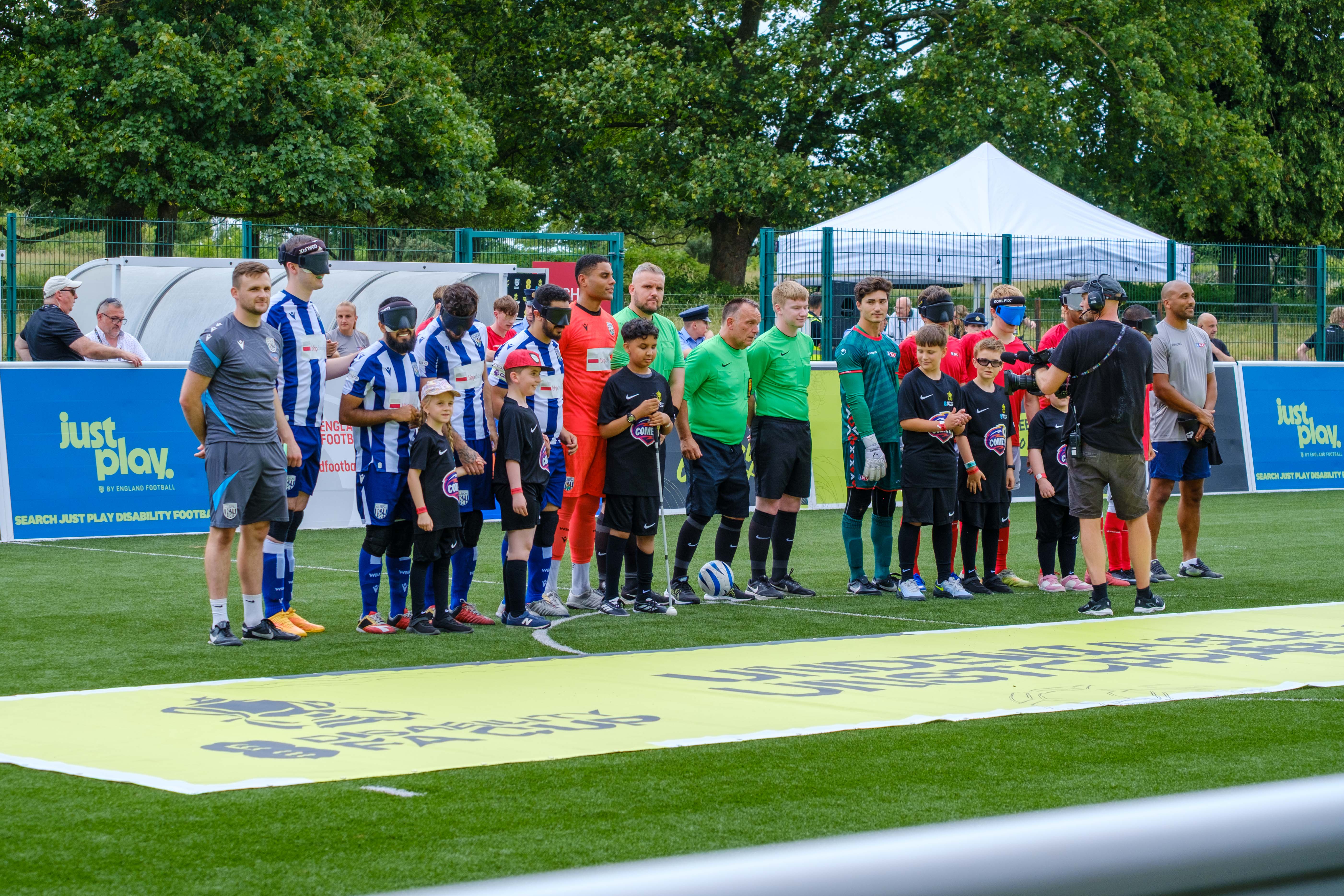 Both teams lined-up with referees and mascots.