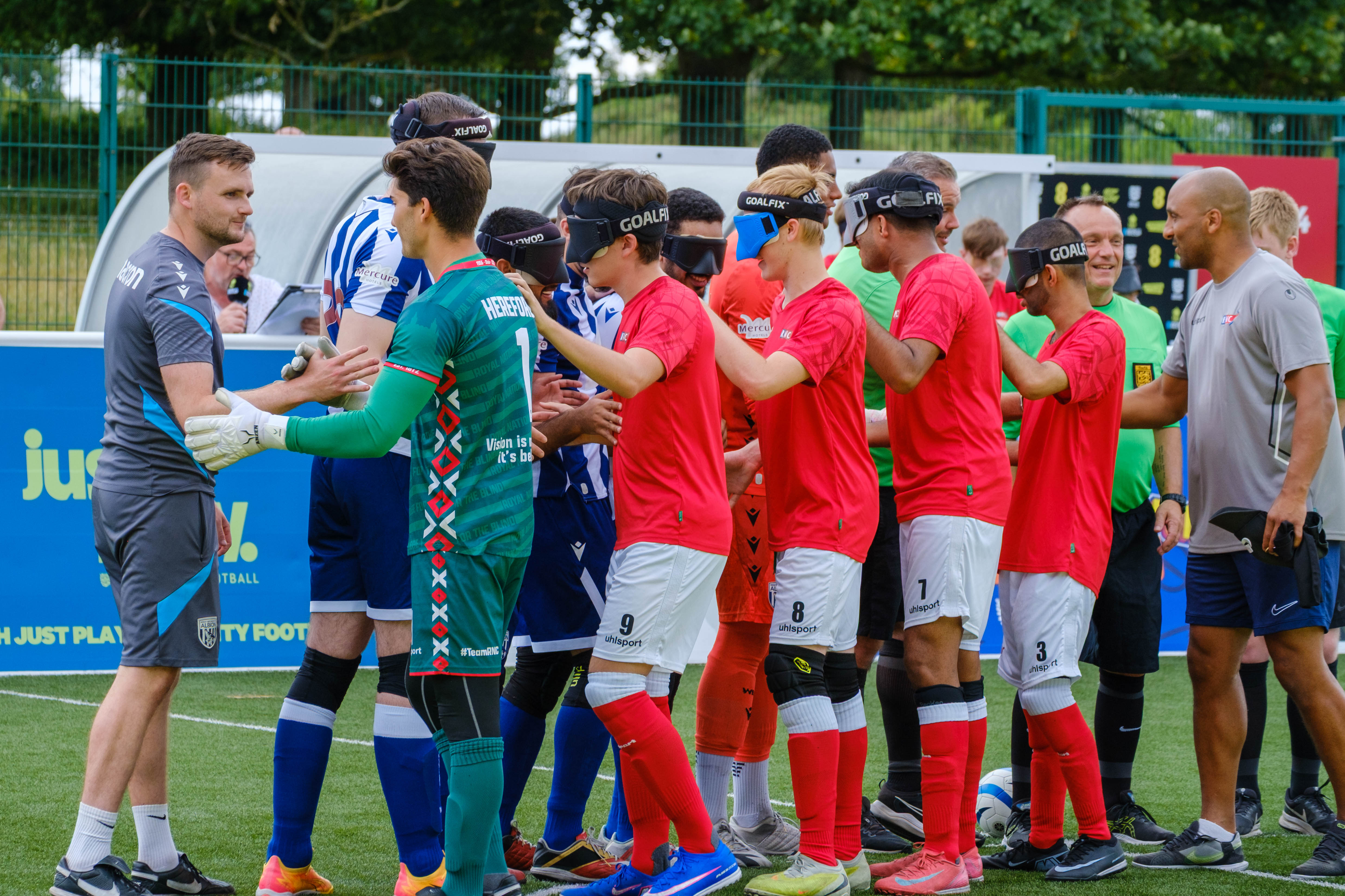 RNC players shaking hands with WBA Blind players.