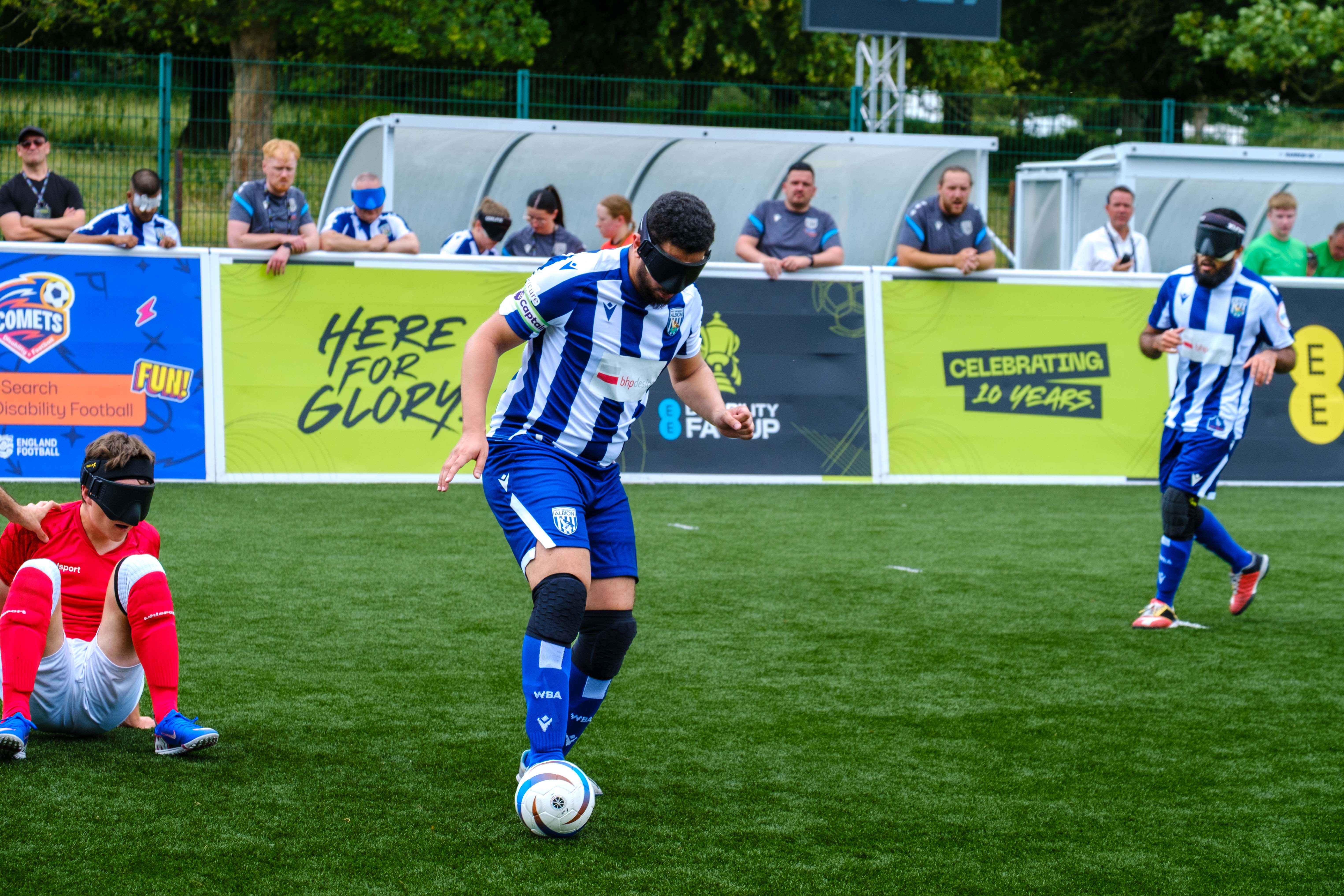 Mo controlling the ball with Eesa in the distance and a RNC player on the floor.