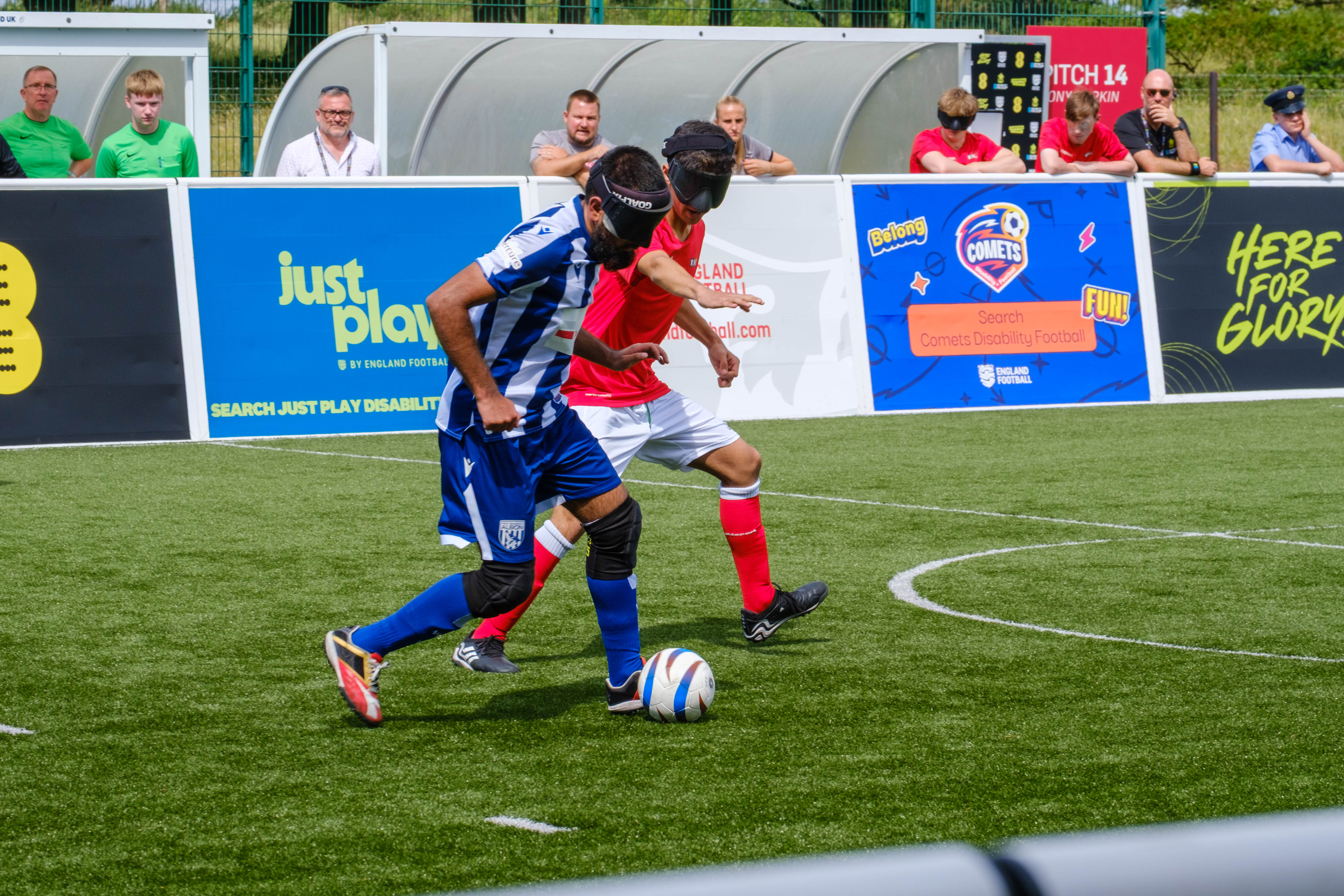 Eesa driving with the ball as a RNC players chases.