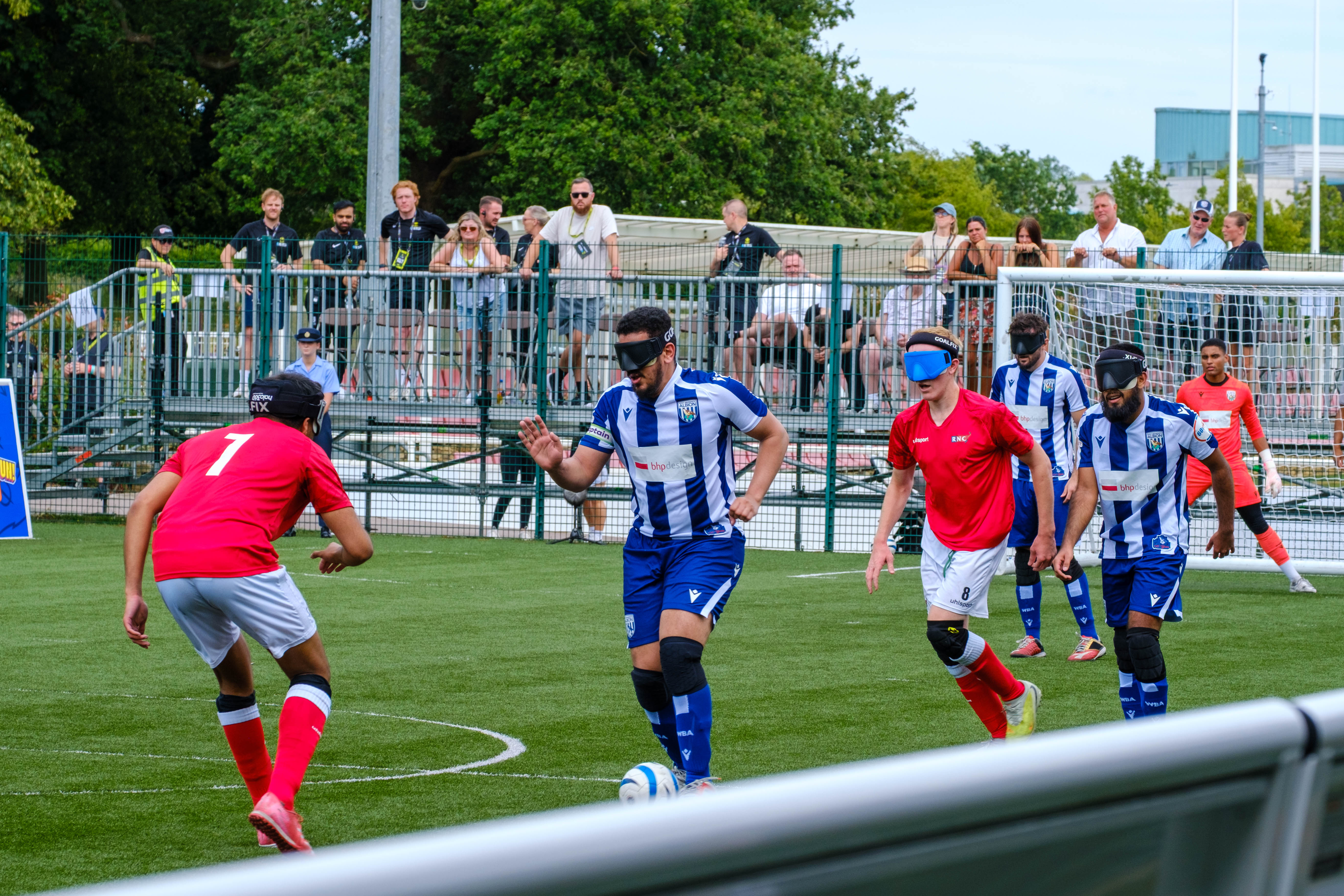Mo Ahmed driving the ball with players chasing.