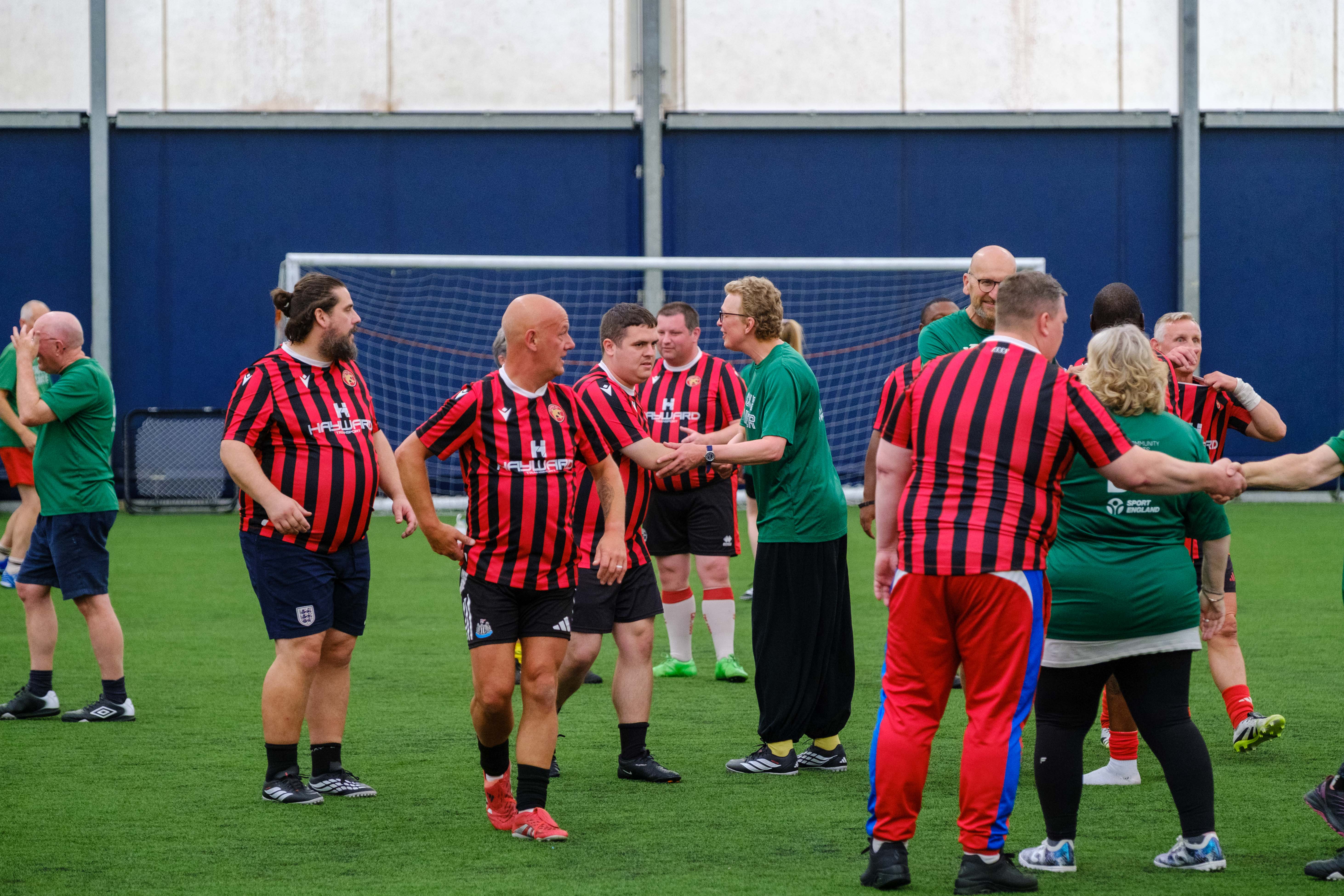 Big C Tackling Cancer and Beat the Block shaking hands after the game.
