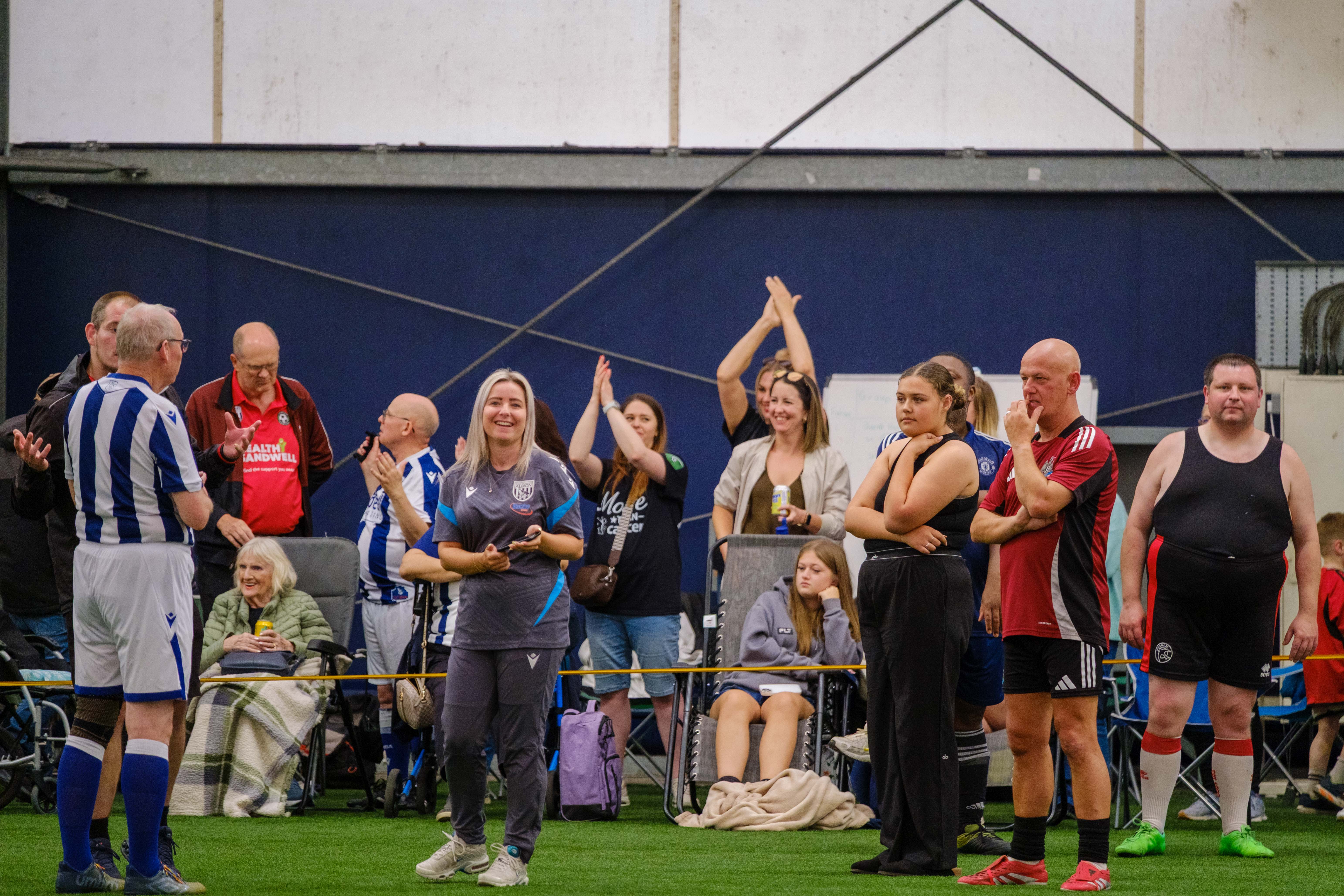 Spectators celebrating on the sideline.